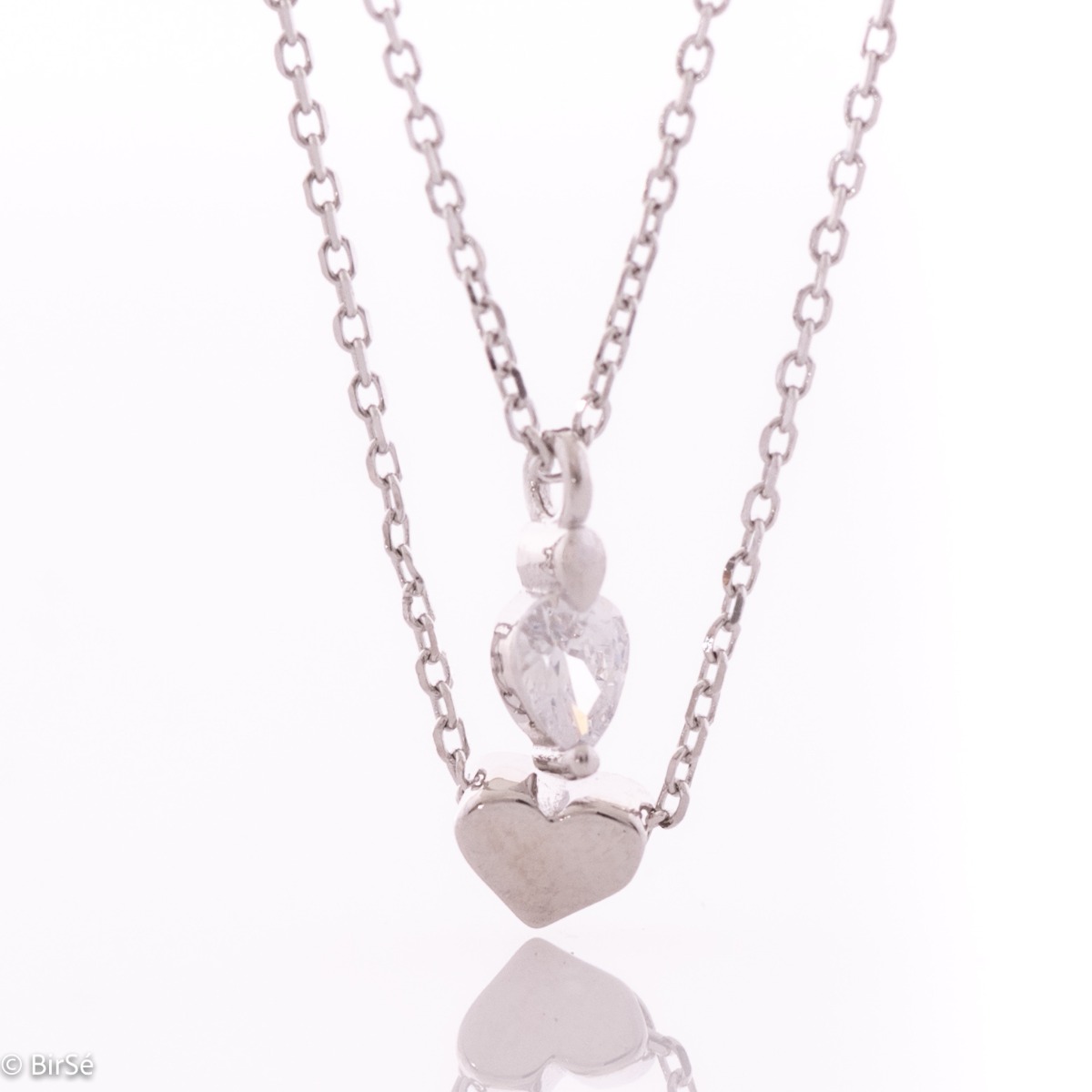 Exquisite design and spectacular pattern of double silver necklace with hearts of soft rhodium silver and dazzling zircon. An original and sought-after piece of jewelry by stylish ladies.