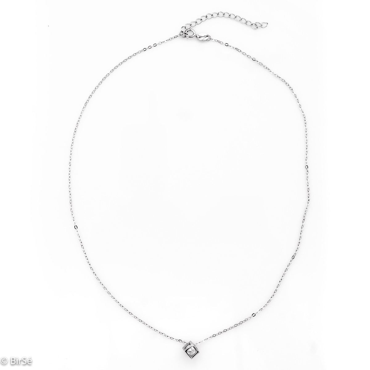 A stylish women's necklace made of sparkling rhodium silver with an elegant cube-shaped pendant, in the center of which a dazzling zircon mystically sparkles.