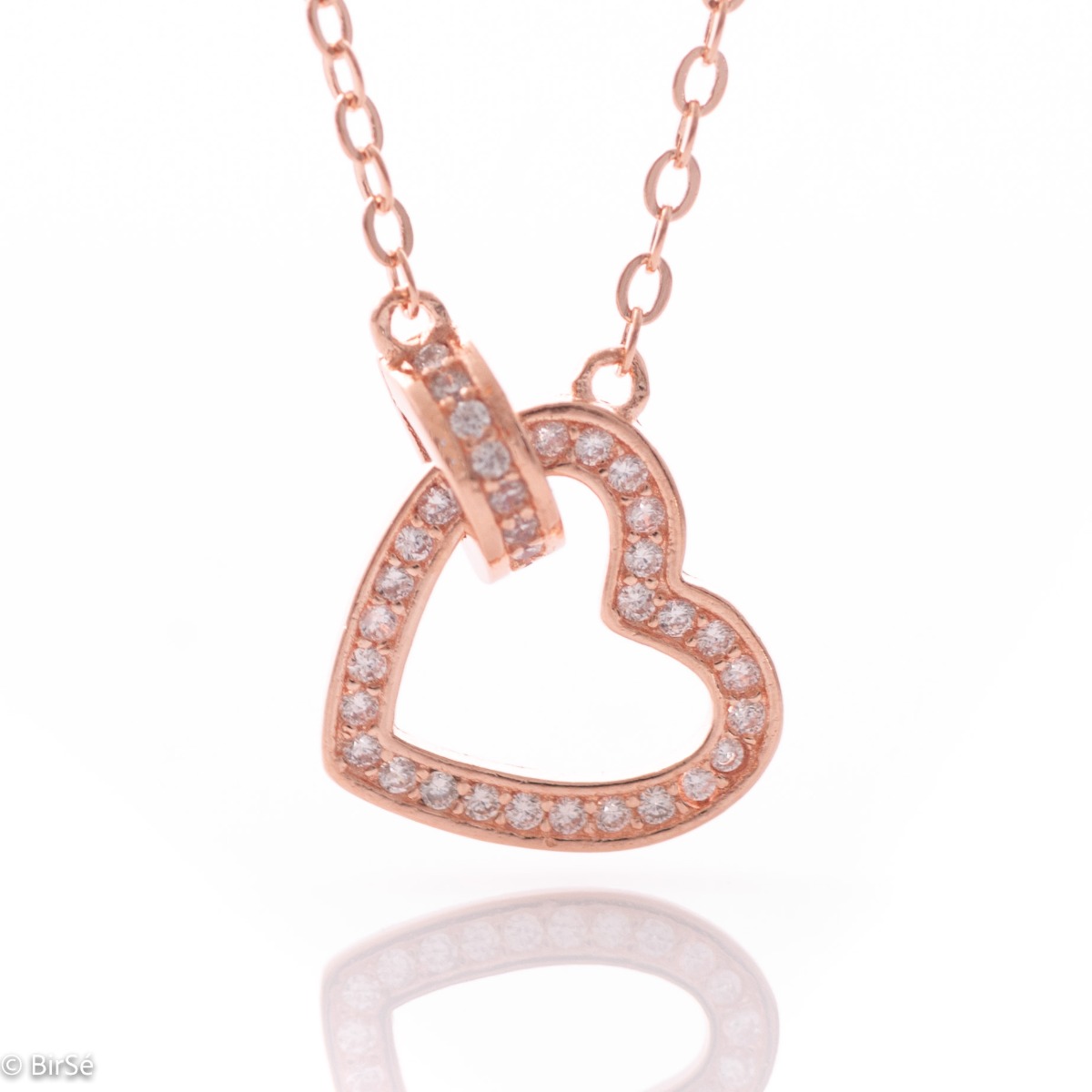 A stylish necklace in soft rose silver with an asymmetrically placed dainty heart, all encrusted with sparkling zircons.