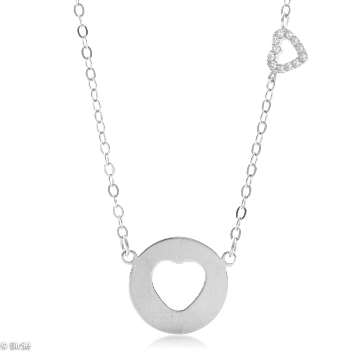 Modern women's necklace made of soft silver with a round plate and a heart cut into it. As an addition, a small heart pendant with zircons is attached to the top of the chain.