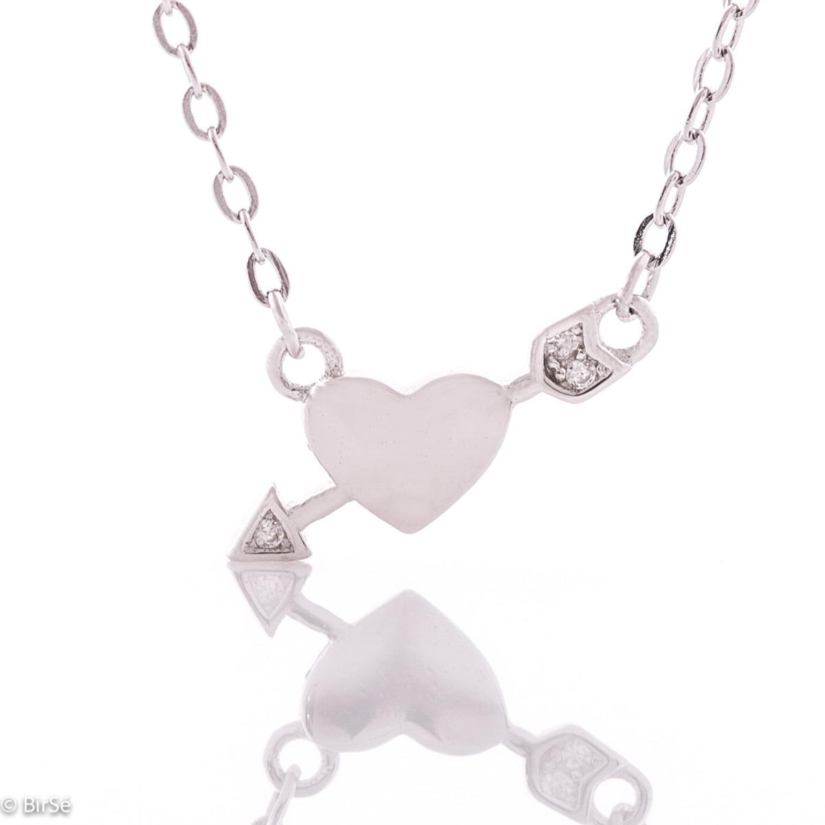 An elegant women's silver necklace with an elegantly crafted heart pierced by the arrow of love. Delicate zircons complete the charm of the jewel.