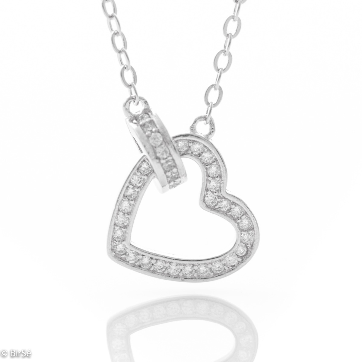 A stylish necklace in soft rhodium silver with an asymmetrically placed dainty heart, all encrusted with sparkling zircons.