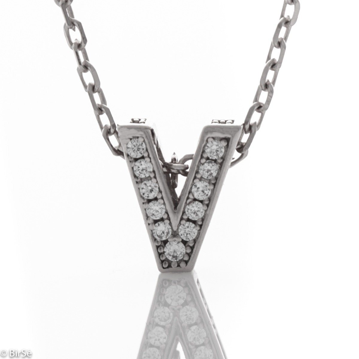 Sophisticated creation of a rhodium-plated silver necklace with the letter V, studded with glittering zircons. An attractive piece of jewelry in which the delicate beauty of silver is skilfully combined with the brilliance of zircons.