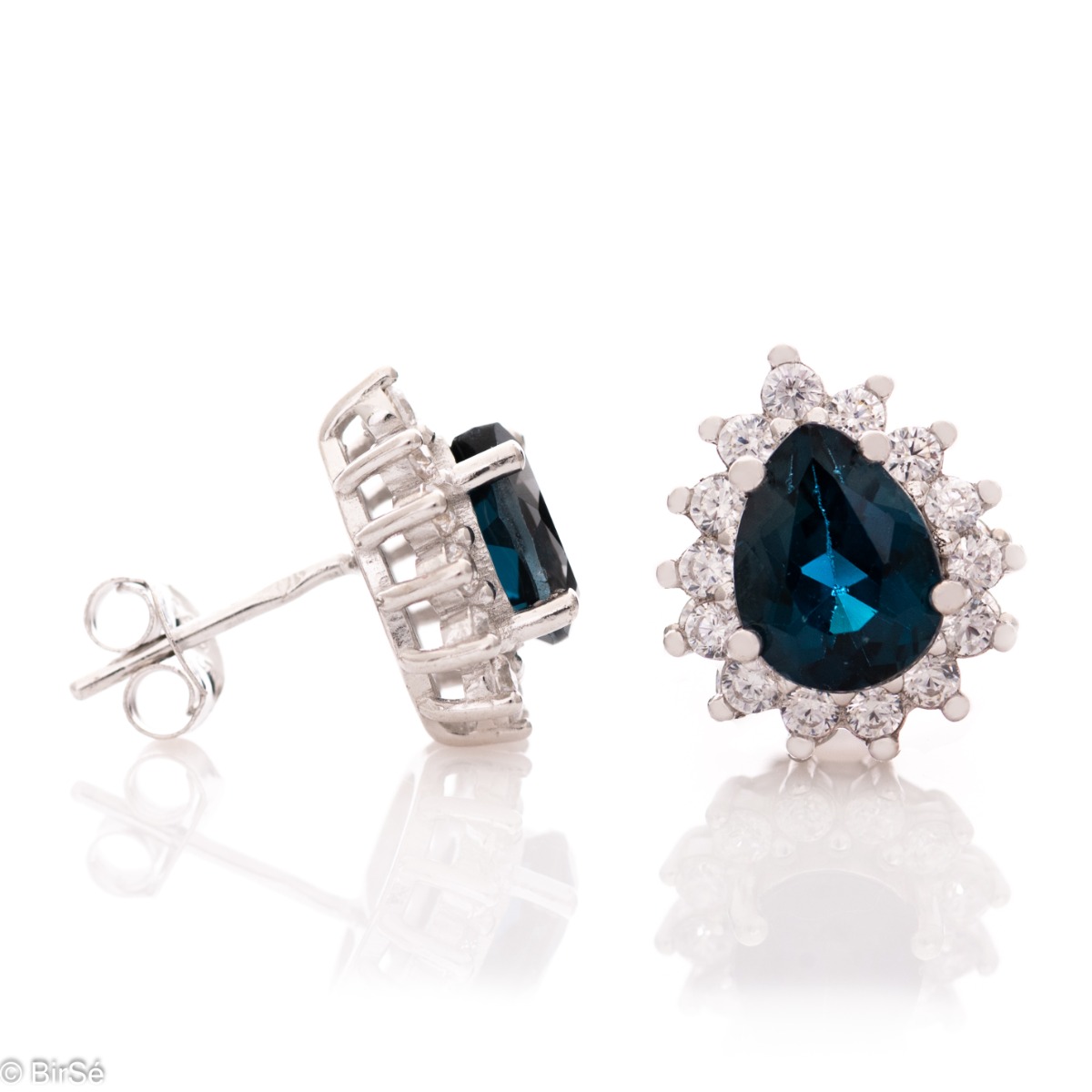 Elegant women's stud earrings with a delicate drop-shaped natural London topaz, surrounded by sparkling zircons and exquisitely crafted in beautiful rhodium silver. In a charming ring and pendant set.