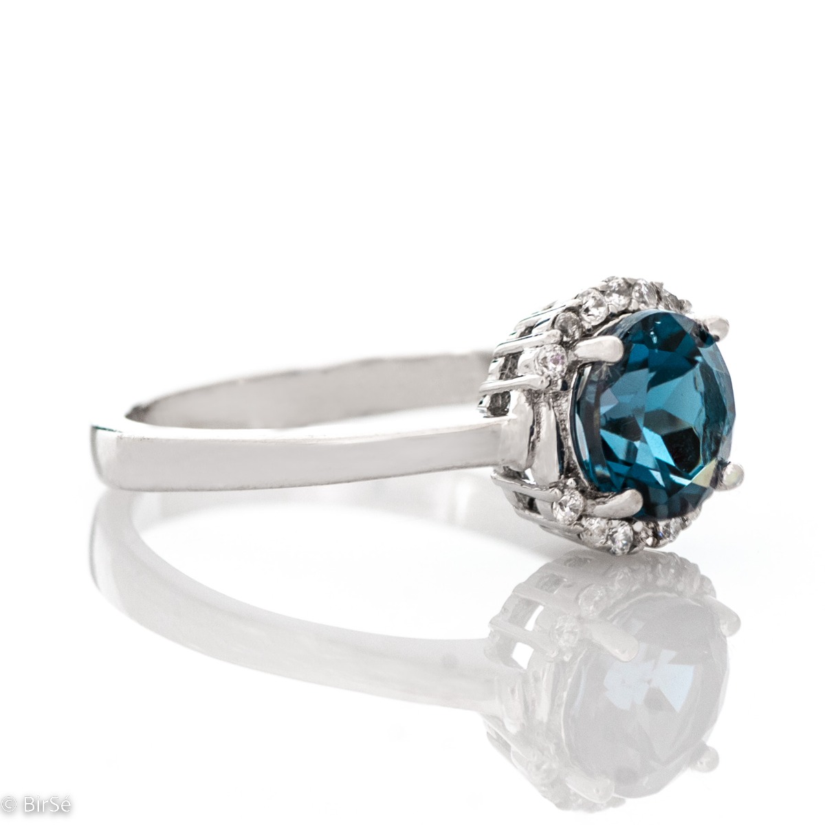 Delicately elegant women's ring made entirely of rhodium-plated silver, exquisite London topaz and the sparkle of fine zircons. It is suitable for combining in a set with earrings and a pendant from the same stylish collection.