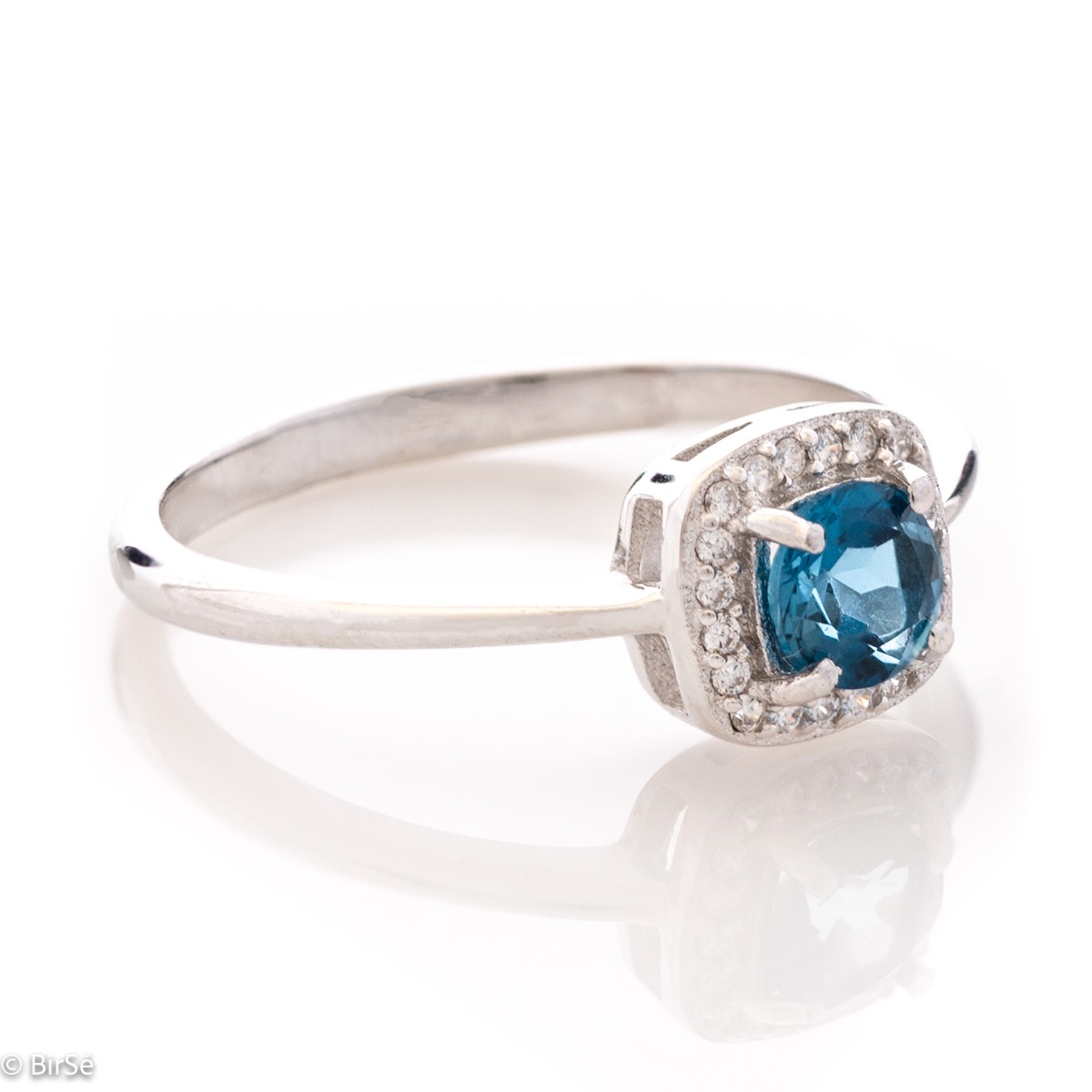 An elegant women's ring with extremely delicate details made of rhodium silver, natural London topaz and sparkling zircon stones. It is suitable for combining in a set with earrings and a pendant from the same collection and the same unique design.