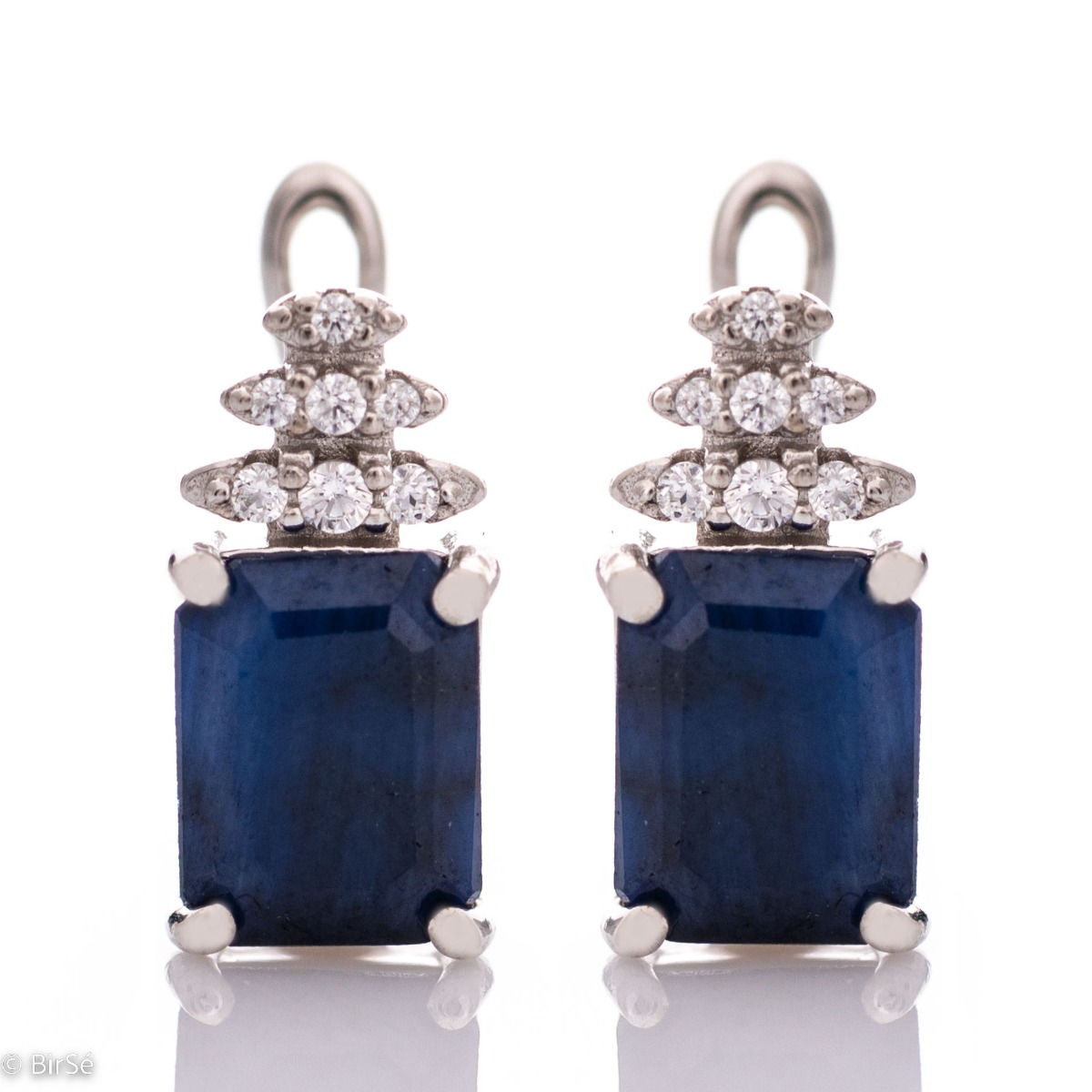 Elegant women's earrings with a spectacular design. Crafted entirely from rhodium-plated sterling silver, a natural baguette-shaped sapphire and sparkling cubic zirconia, with the ladies' favorite English clasp. In a sophisticated ring and pendant set in 