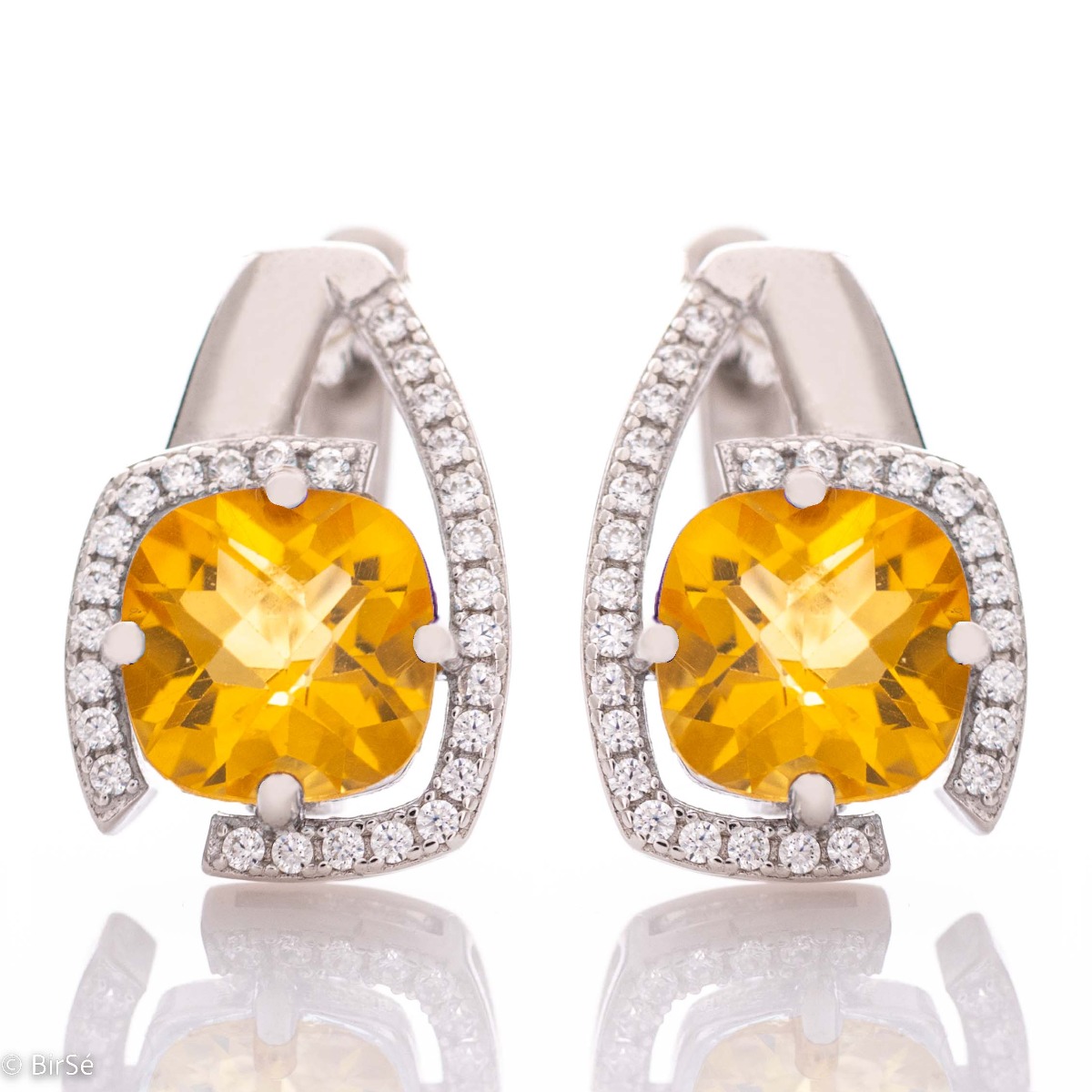 Elegant ladies earrings with English clasp and radiant natural citrine, complemented by sparkling zircons and a stylish design entirely in rhodium silver.