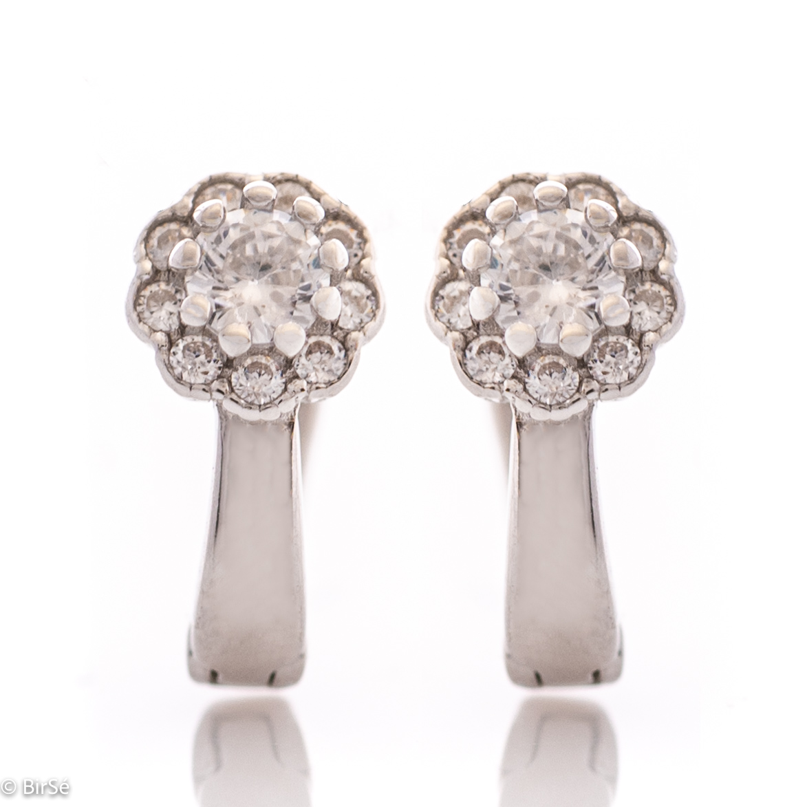 Charming ladies earrings made of rhodium silver with a comfortable English clasp. The front side of the earrings is in the shape of exquisite flowers, carefully crafted from zircons.