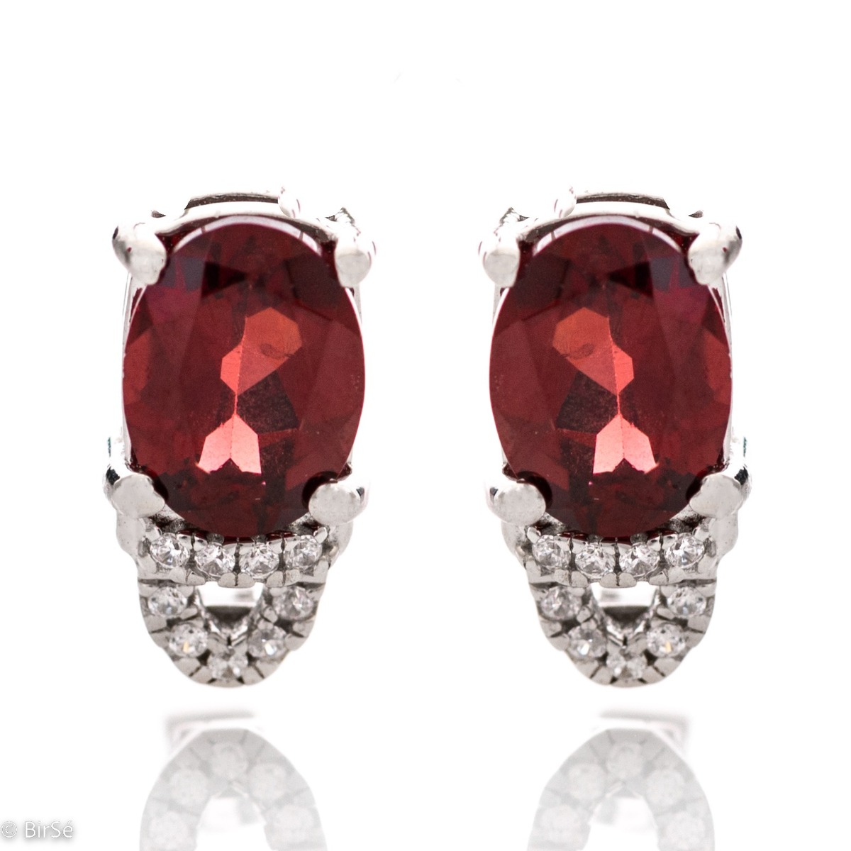 Elegant women's earrings with English clasp and precision craftsmanship entirely of rhodium-plated silver, combined with radiant natural garnet and sparkling zircons. They can be combined with a ring and pendant of the same model.