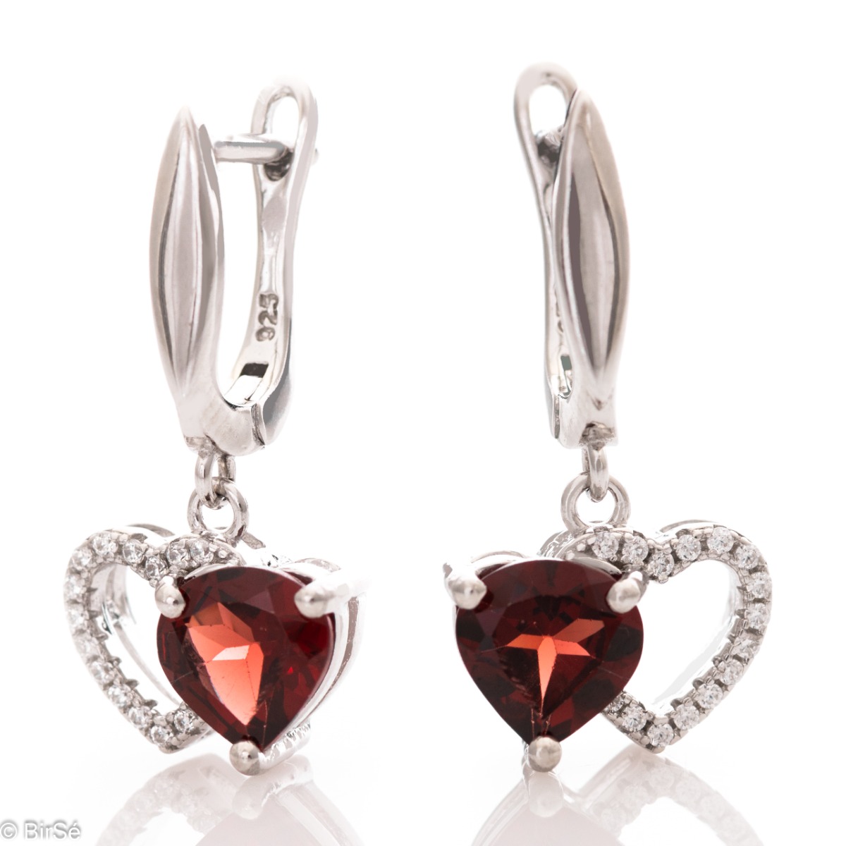 Delicate dangle earrings with sparkling natural garnet combined with beautiful rhodium silver and fine sparkling zircons. Elegant design with comfortable English fastening. Complete with a ring with the same charming design.