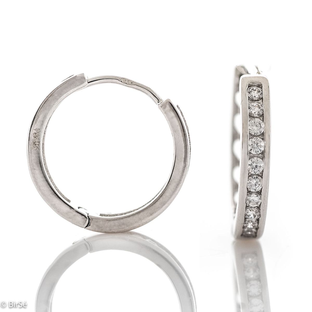 Graceful ladies' earrings - rings made of rhodium-plated silver with a comfortable English clasp. The front of the earrings is decorated with dazzling zircons. Suitable jewelry for your everyday life.