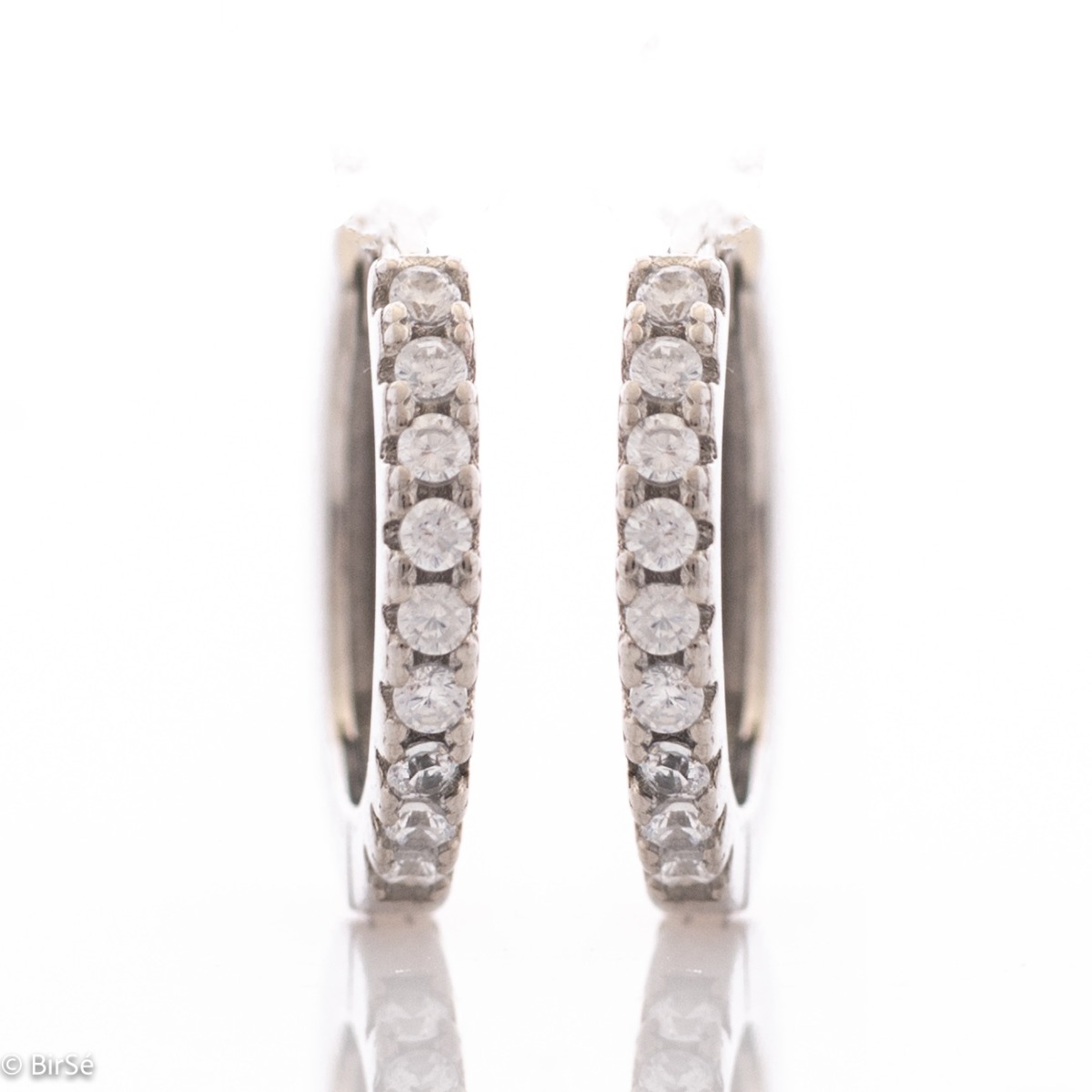 Small elegant silver earrings - rings, entirely made of rhodium-plated silver, decorated with sparkling zircons. The fastening is extremely comfortable and suitable for small children as well.