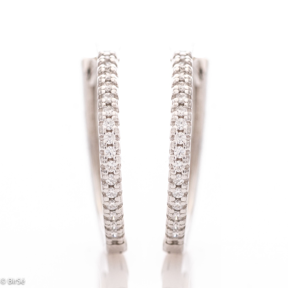 A stylish model of women's earrings - rings, with an elegant design, completely formed by combining rhodium-plated silver with shiny zircons. The fastening is English - comfortable and practical. A wonderful mood for your everyday life with BirSe earrings