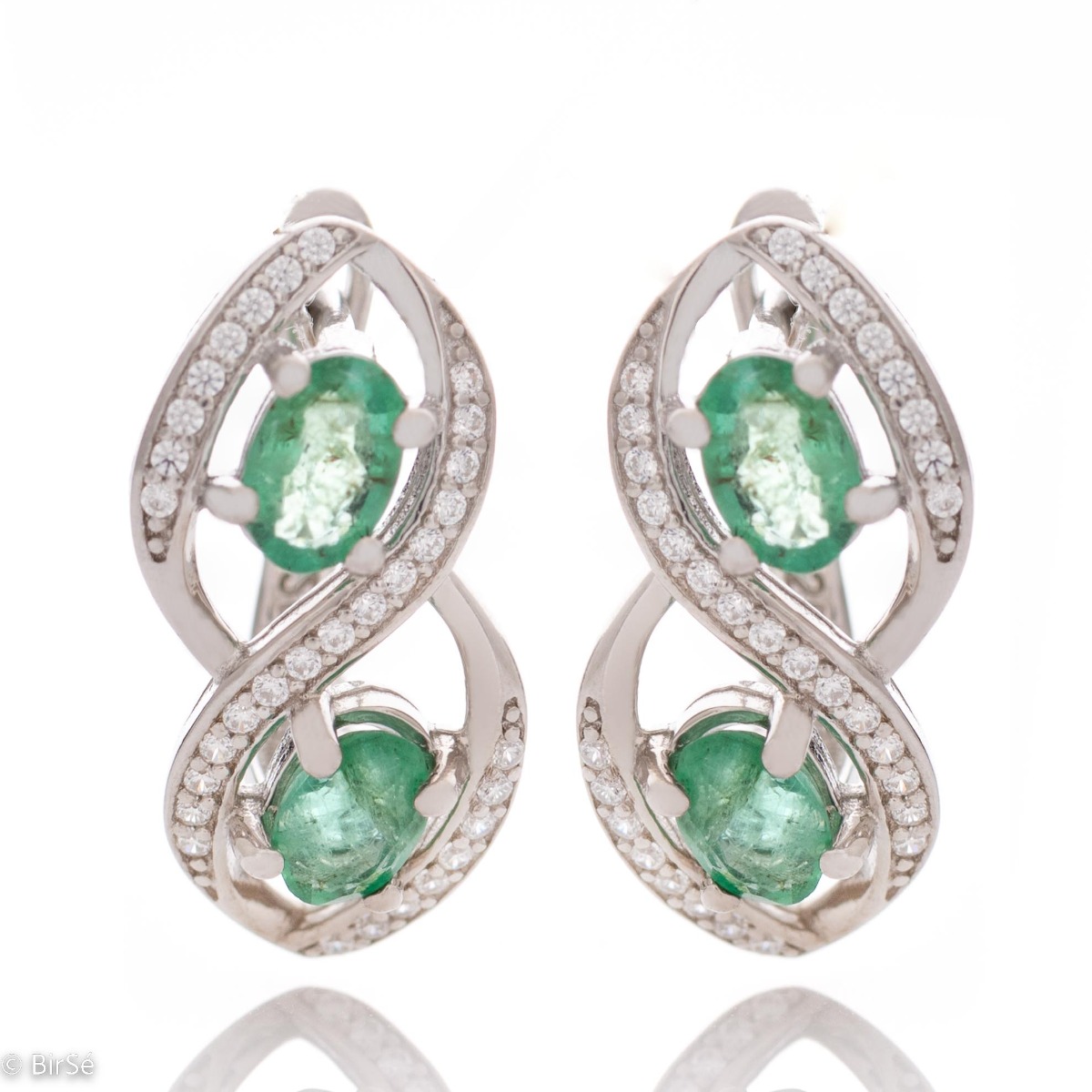 Stunning infinity rhodium-plated sterling silver earrings, exquisitely embellished with glittering cubic zirconias encircling gorgeous emeralds. Complete with a ring of the same design.