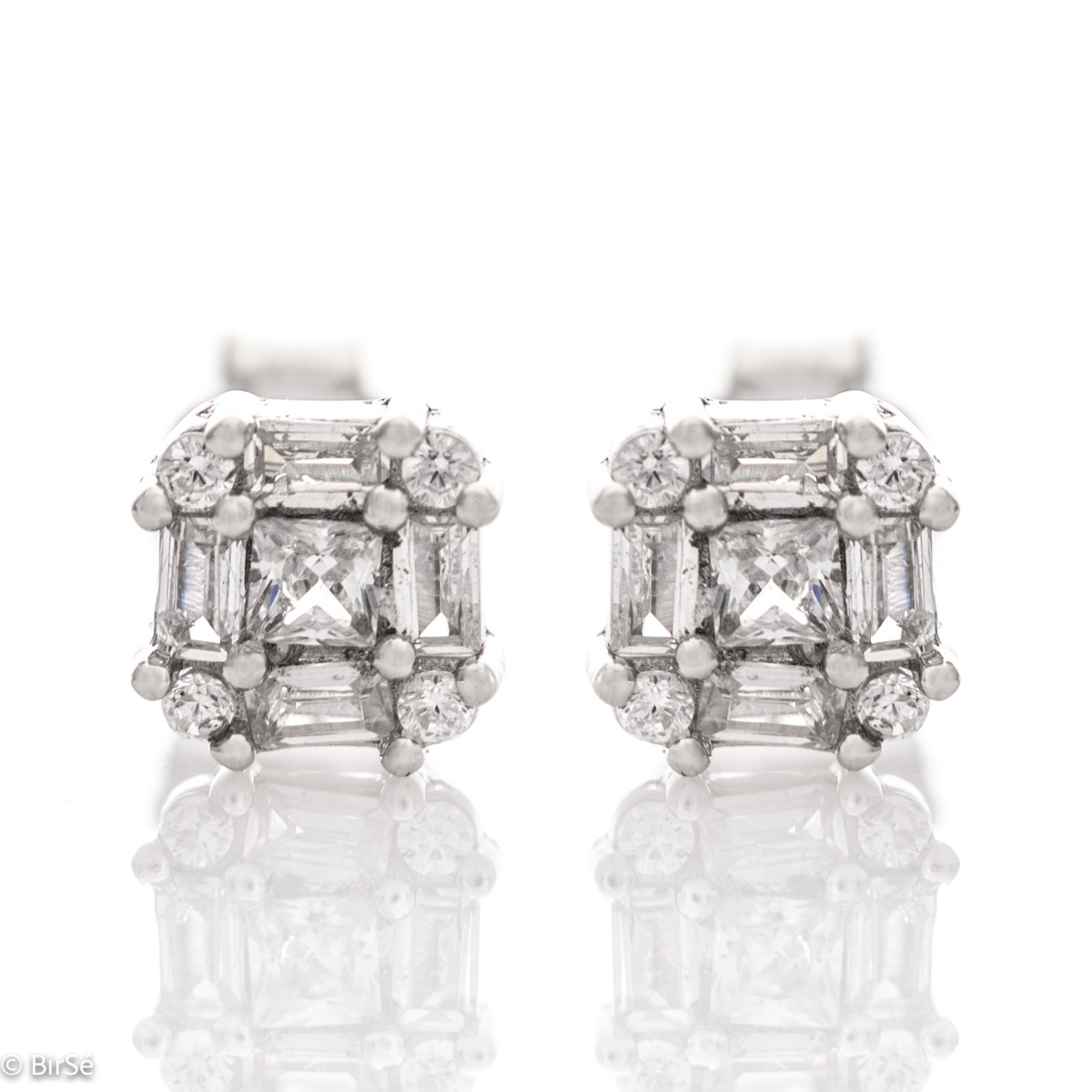 Captivating earrings "Women's caprice" made entirely of fine rhodium silver and fine zircons of various shapes. The fastening is with a pin, and the earrings are suitable for any style and outfit.