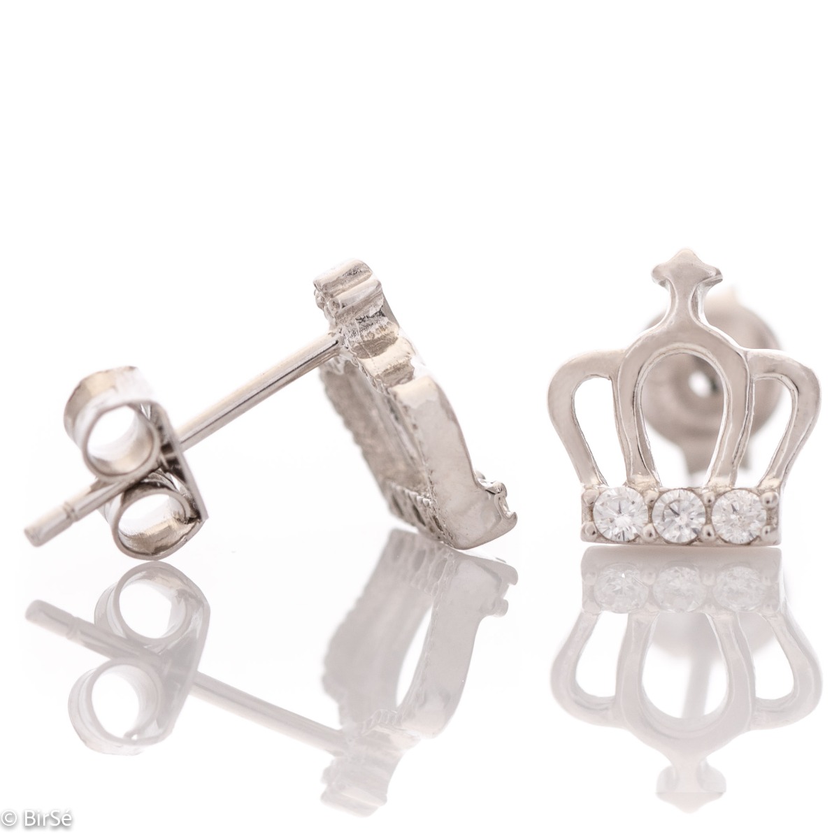 Delicate women's earrings in fine rhodium silver, with elegantly shaped crowns, at the base of which charmingly sparkle zircons. The earrings are fastened with a pin - extremely comfortable and practical. A suitable gift for any princess.