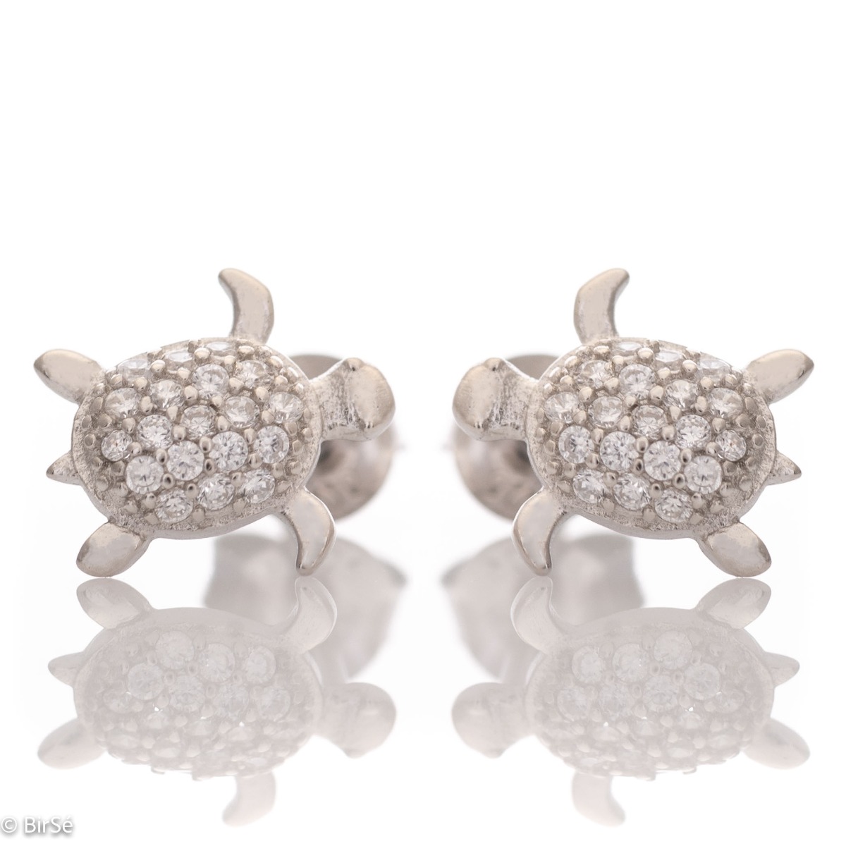 Delicate women's earrings in fine rhodium silver, with designer shaped turtles studded with sparkling zircons. The earrings are fastened with a pin - extremely convenient and secure. A suitable gift for any lady, being a symbol of constancy and wisdom.