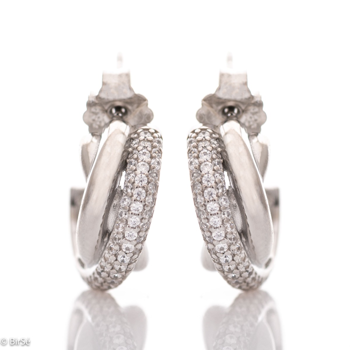 Stylish earrings with a delicate half hoop design, braided elements of rhodium silver, decorated with sparkling zircons. The earrings have a pin fastening - practical and secure.