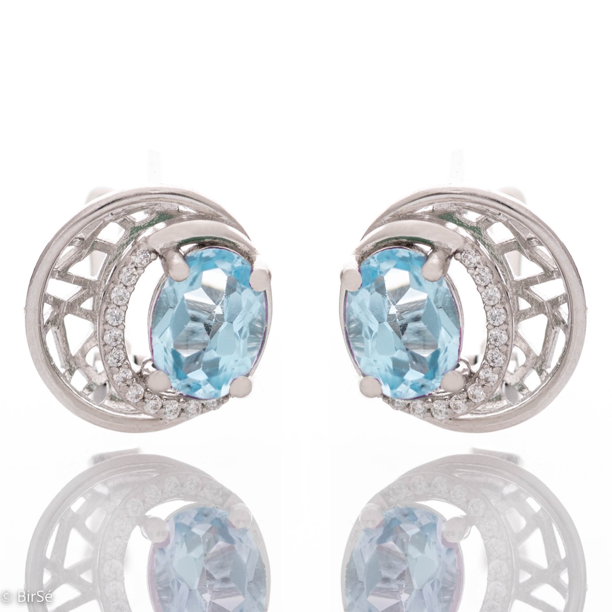 Elegant silver earrings with a modern look and English clasp. Stylish designer craftsmanship from a fine combination of rhodium-plated silver with captivating natural blue topaz. Complete with silver pendant and silver ring from the same collection.