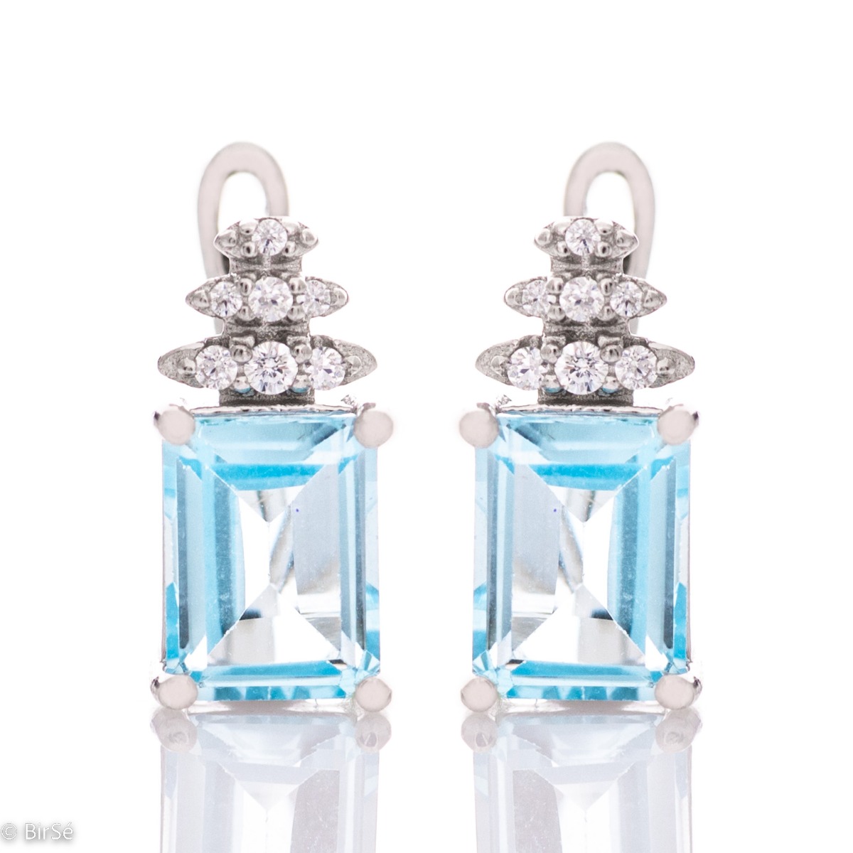 A fairy tale magic – delicate earrings made of rhodium silver with an English clasp. A combination of natural blue topaz and zircons in an elegant design.