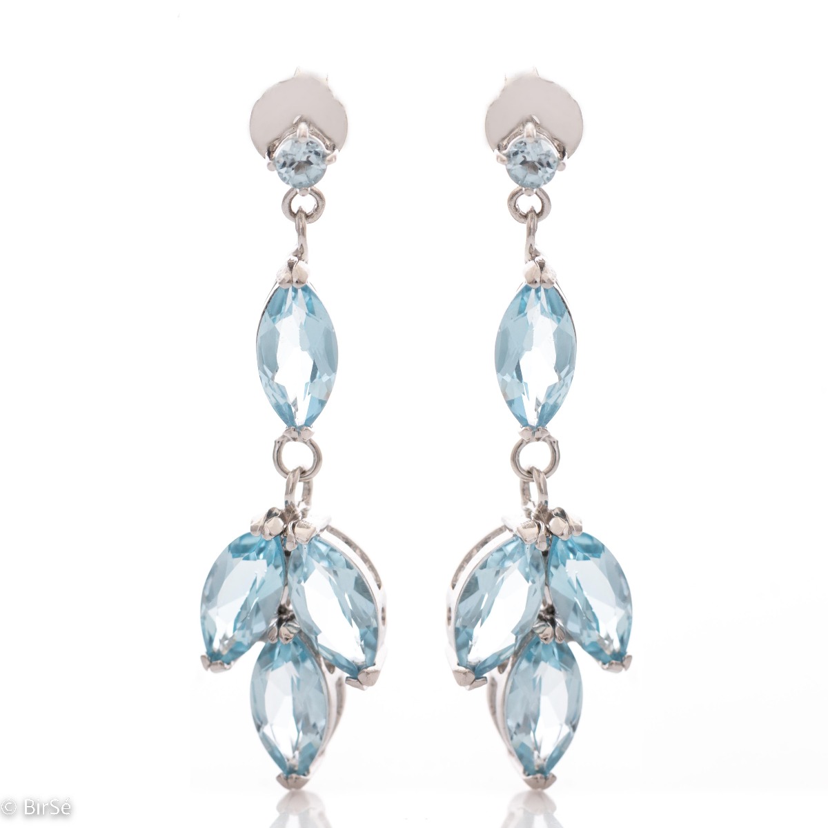 Elegantly crafted drop earrings of divinely beautiful blue topazes. The earrings are made of rhodium-plated silver, which, combined with the captivating topaz, will light up your face and give you a regal glow.