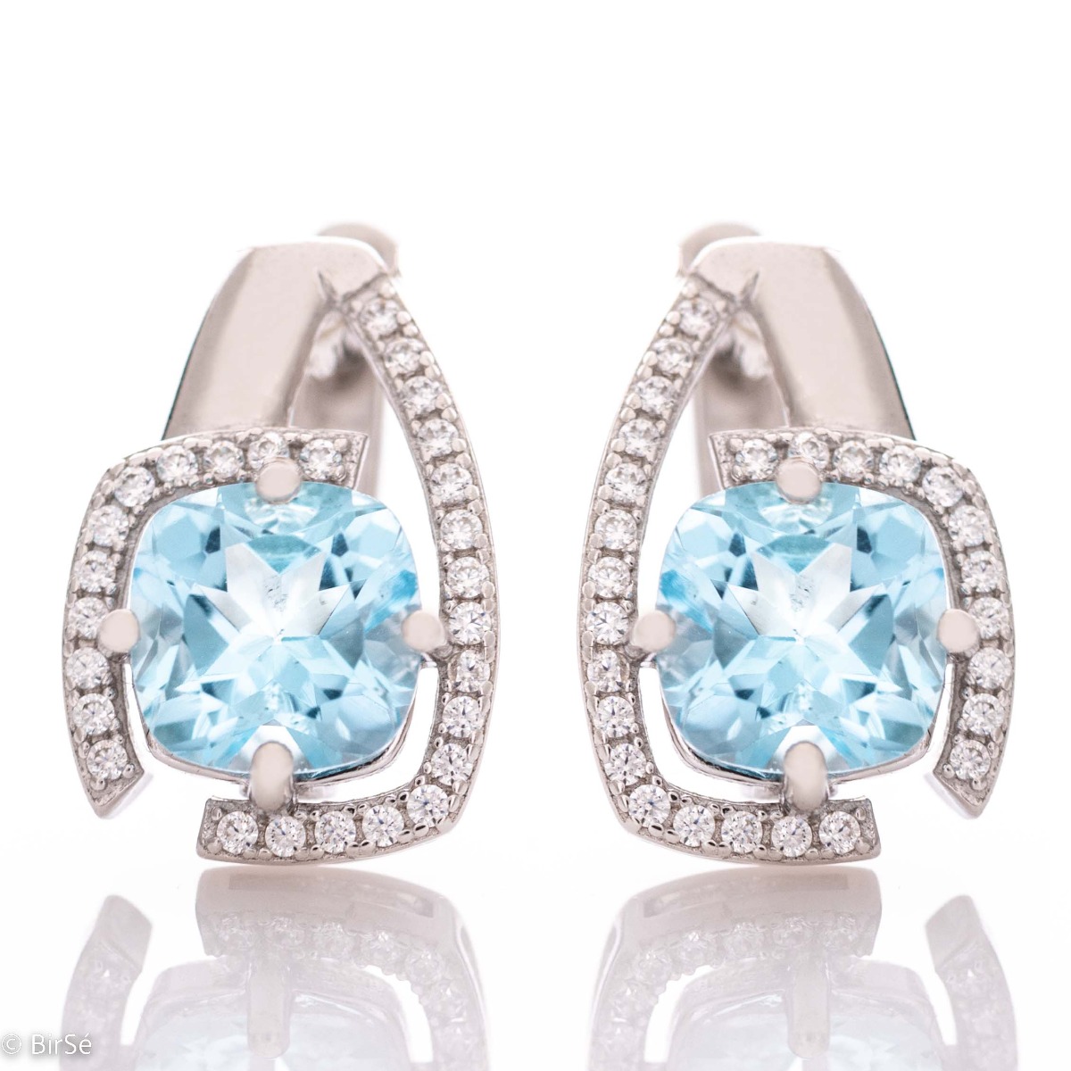 Elegant women's earrings with English clasp and radiant natural topaz, complemented by sparkling zircons and a stylish design entirely in rhodium silver.