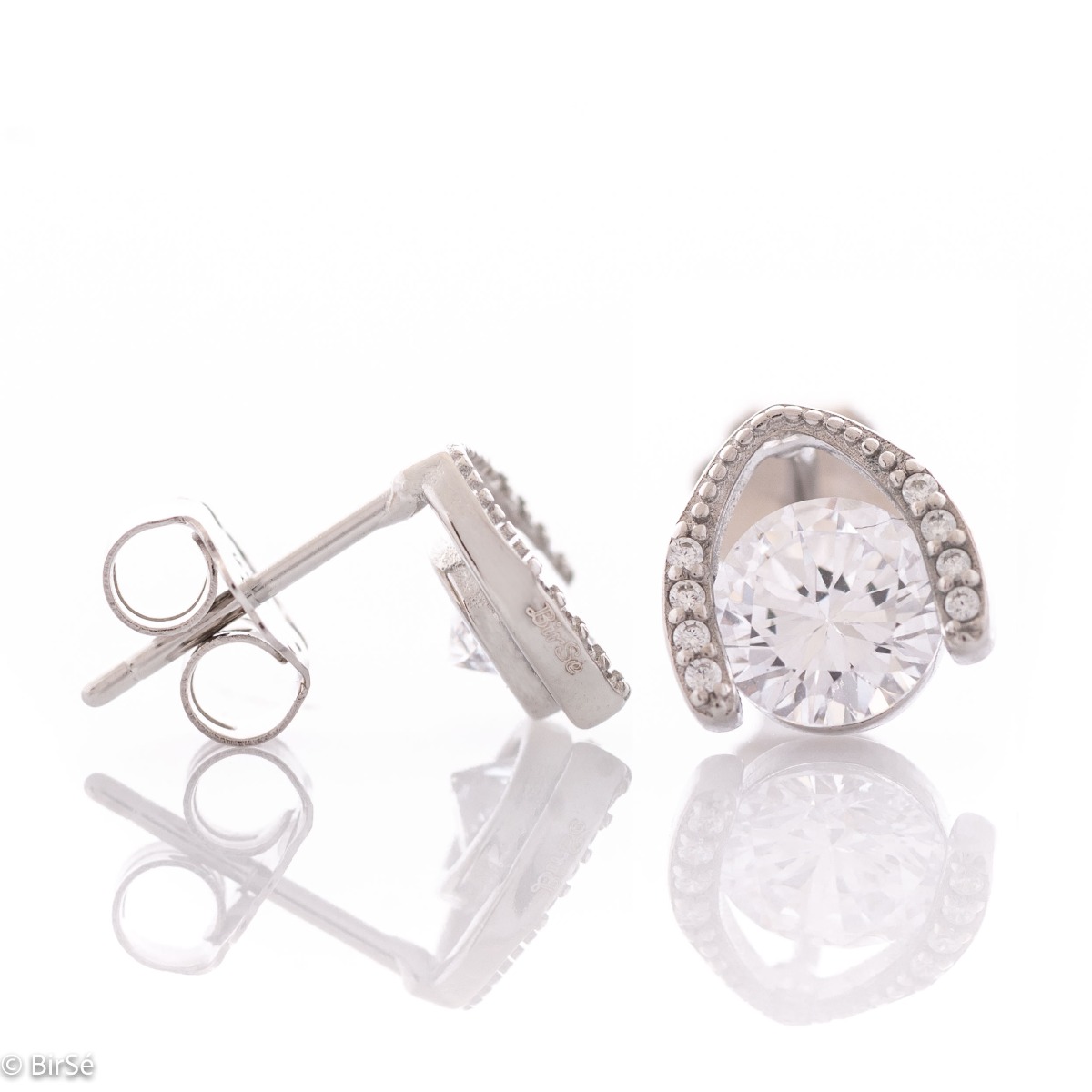 Charming women's earrings, masterfully crafted from fine rhodium silver with an elegant design. The elements are beautifully sculpted, dazzling zircons magically sparkle on the silver, and the pin fastening is comfortable and practical.