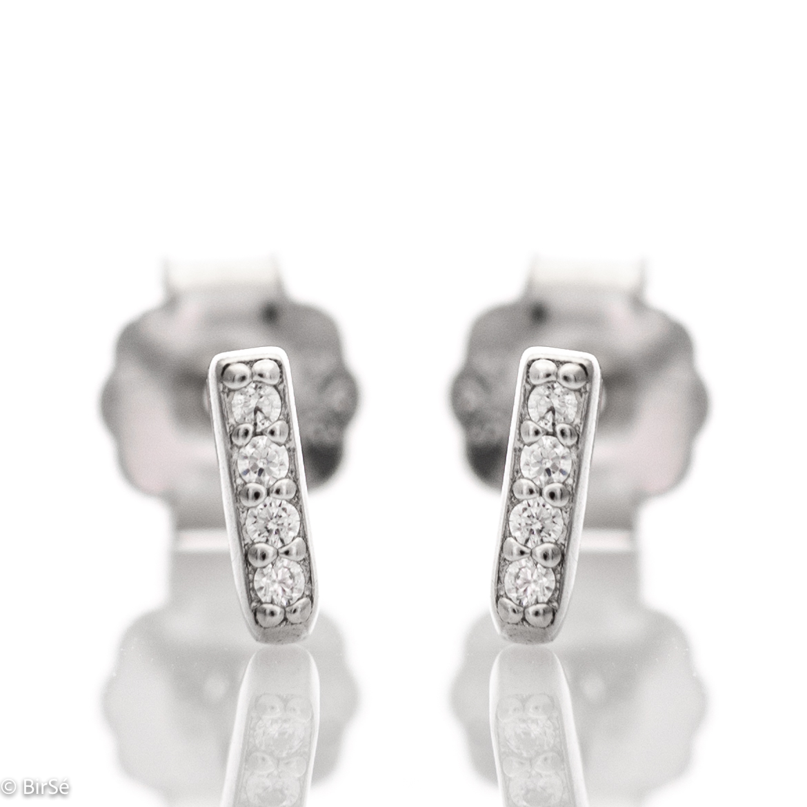 Simple earrings made with an elegant design of the elements of rhodium silver and sparkling zircons. The fastening is with a pin - secure and preferred by the ladies.