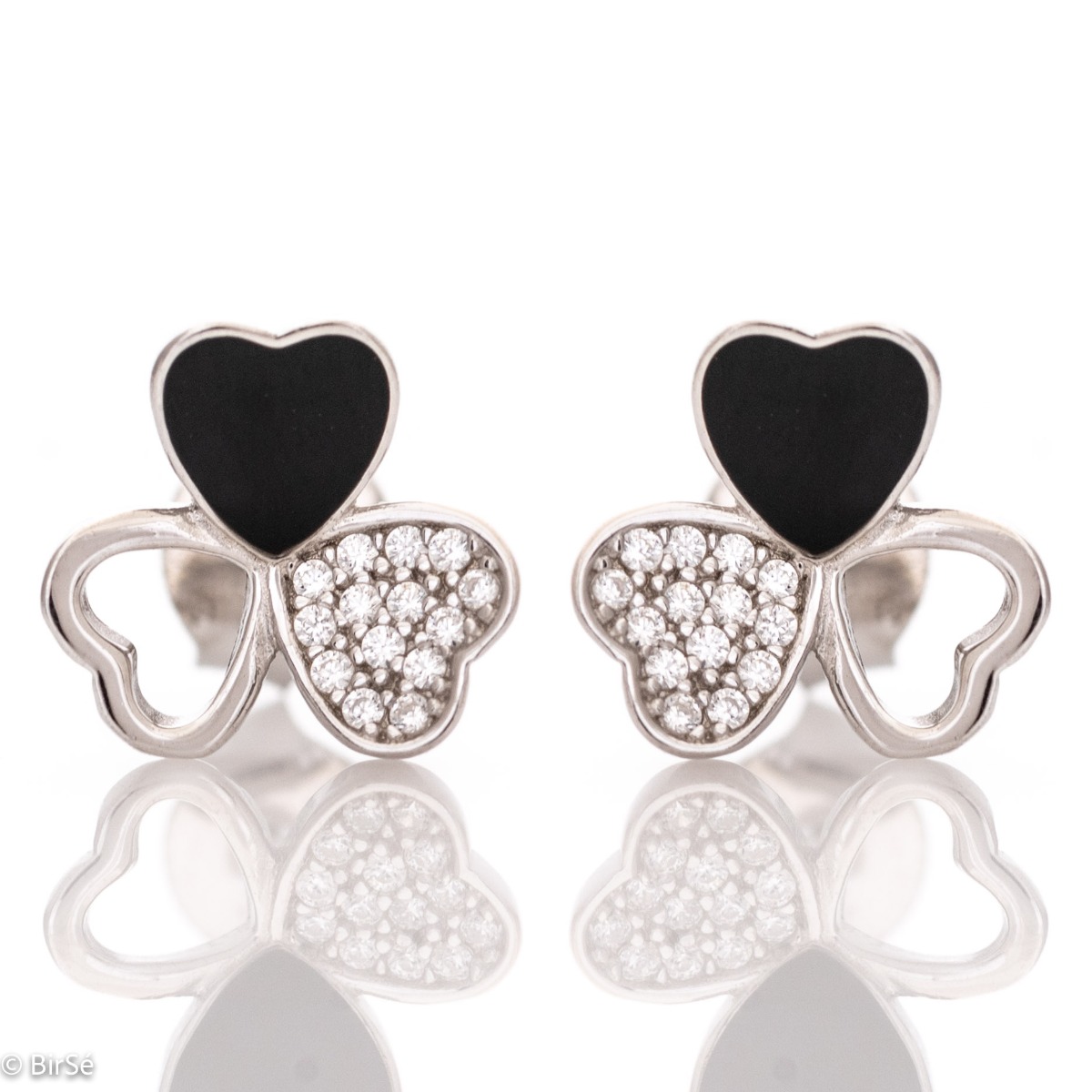 Delicate women's earrings in fine rhodium silver, with an interesting design layout of a charming clover, with black enamel petals and zircons. Featuring a three-leaf clover for luck and happiness, the earrings are a suitable gift for a girlfriend or belo