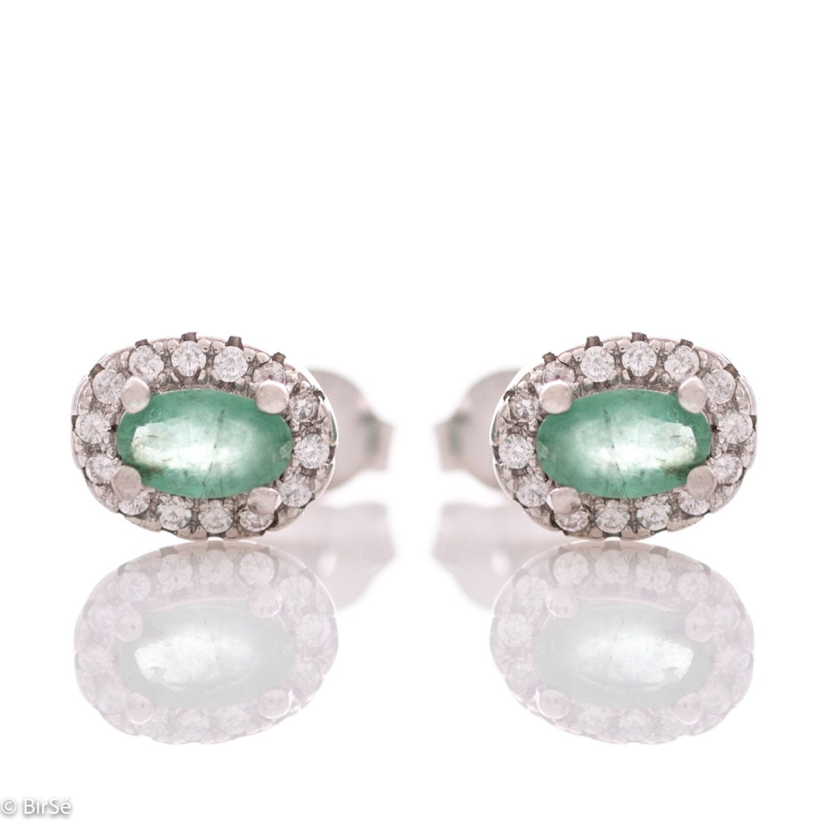 Stylish women's earrings with an elegantly shaped pattern of rhodium-plated silver and a natural emerald stone, beautifully surrounded by dazzling zircons.