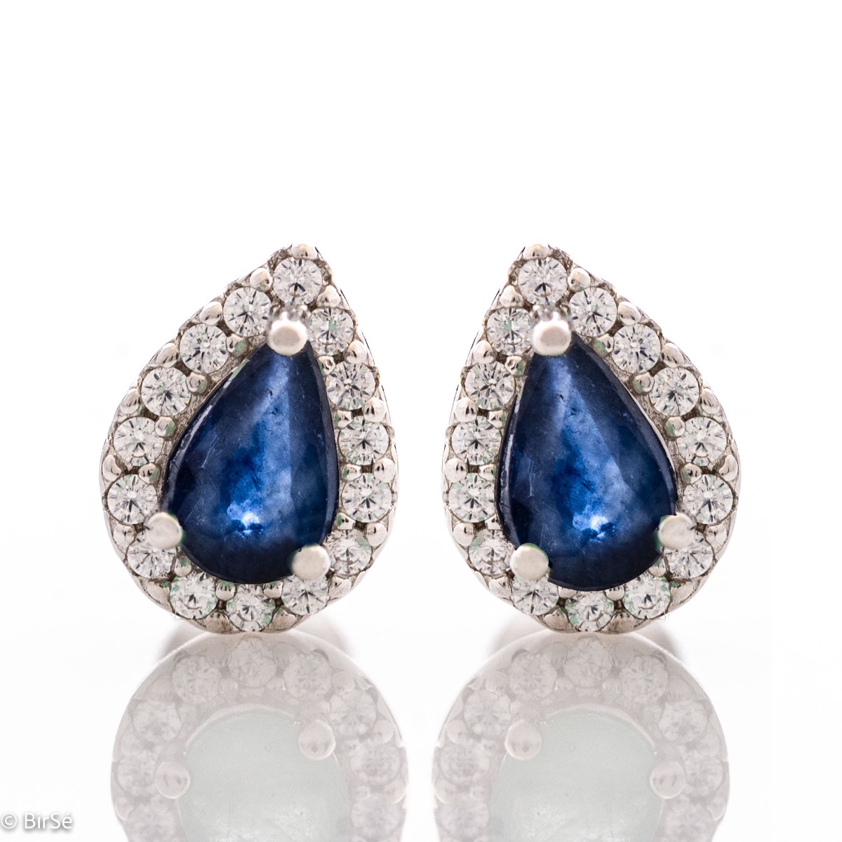 Radiant stud earrings delicately crafted in a teardrop shape and finely rhodium-plated sterling silver, complemented by exquisite natural sapphires and sparkling zircons.