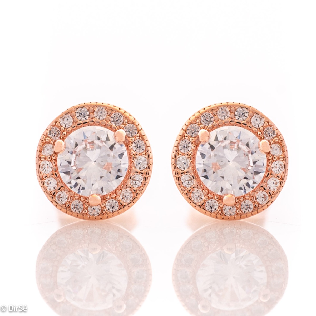 Fine sterling silver stud earrings with round and precise craftsmanship entirely in rhodium-plated rose silver, combined with numerous sparkling cubic zirconias and a central one.