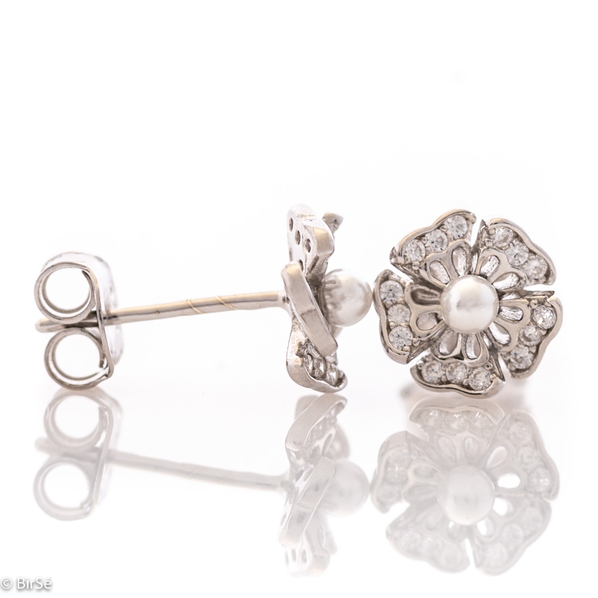 Charming flower shaped soft rhodium silver stud earrings encrusted with zircons and a charming pearl in the center. Pin fastening is comfortable and secure for little and big ladies.