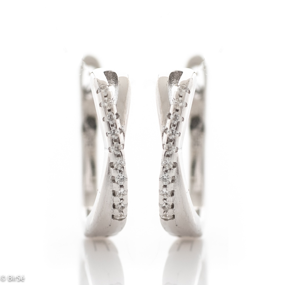 Elegant women's earrings made of rhodium-plated fine silver. The earrings are decorated with delicate zircons, with a stylish design and a comfortable English clasp. A wonderful gift for your beloved woman.