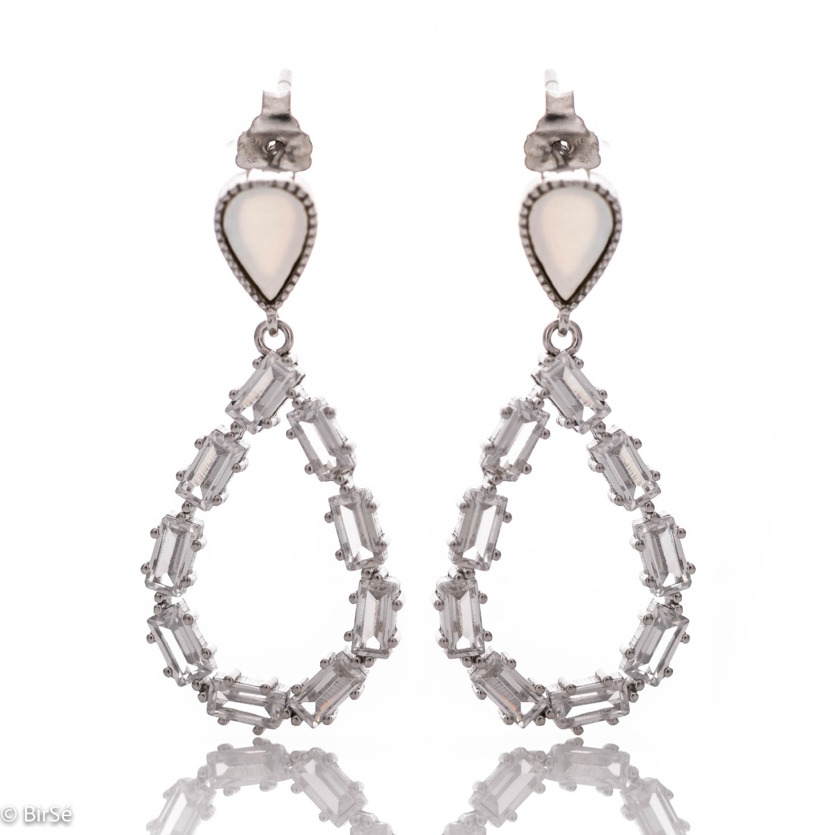 Captivating "Tears" dangling earrings made of fine rhodium silver with a modern design, decorated with glittering baguette-shaped zircons. Pin fastening - practical and comfortable.