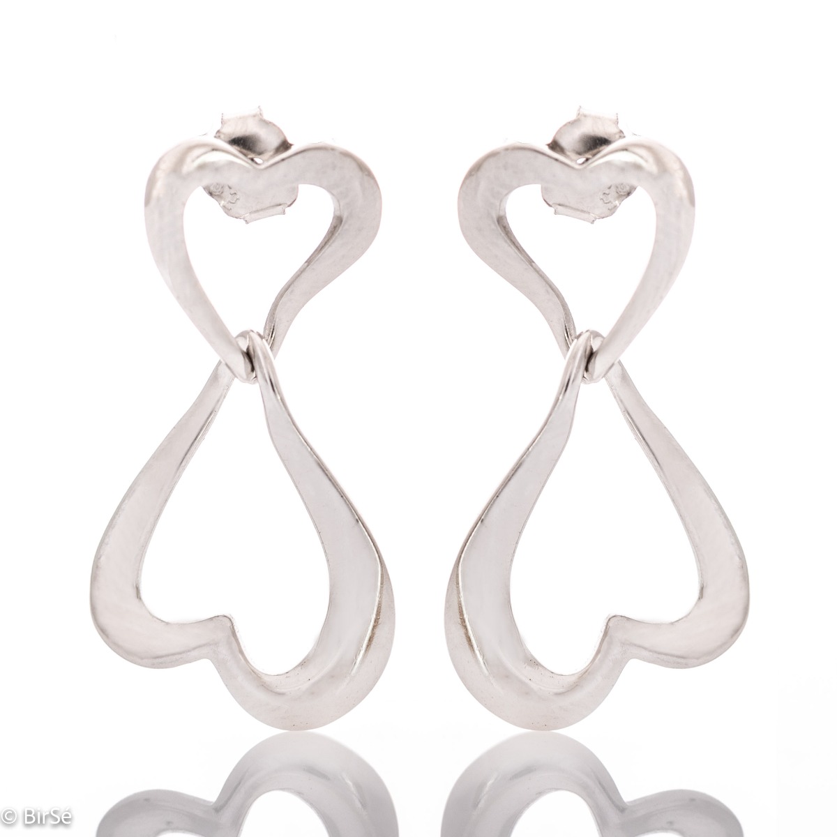 Exquisitely crafted, our new drop stud earrings feature a stylish design featuring two rhodium-plated silver hearts elegantly entwined in a charming embrace.