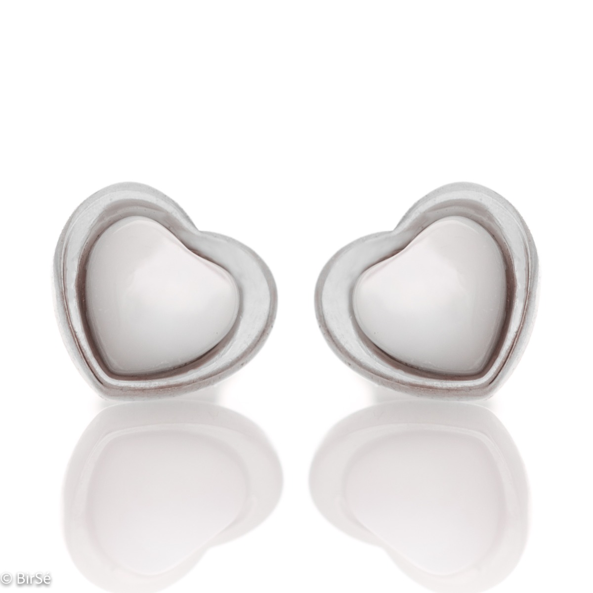 Elegant women's earrings made entirely of fine rhodium-plated silver in the shape of a heart. Their core is shaped from a beautiful milky white stone, and the fastening is with a pin.