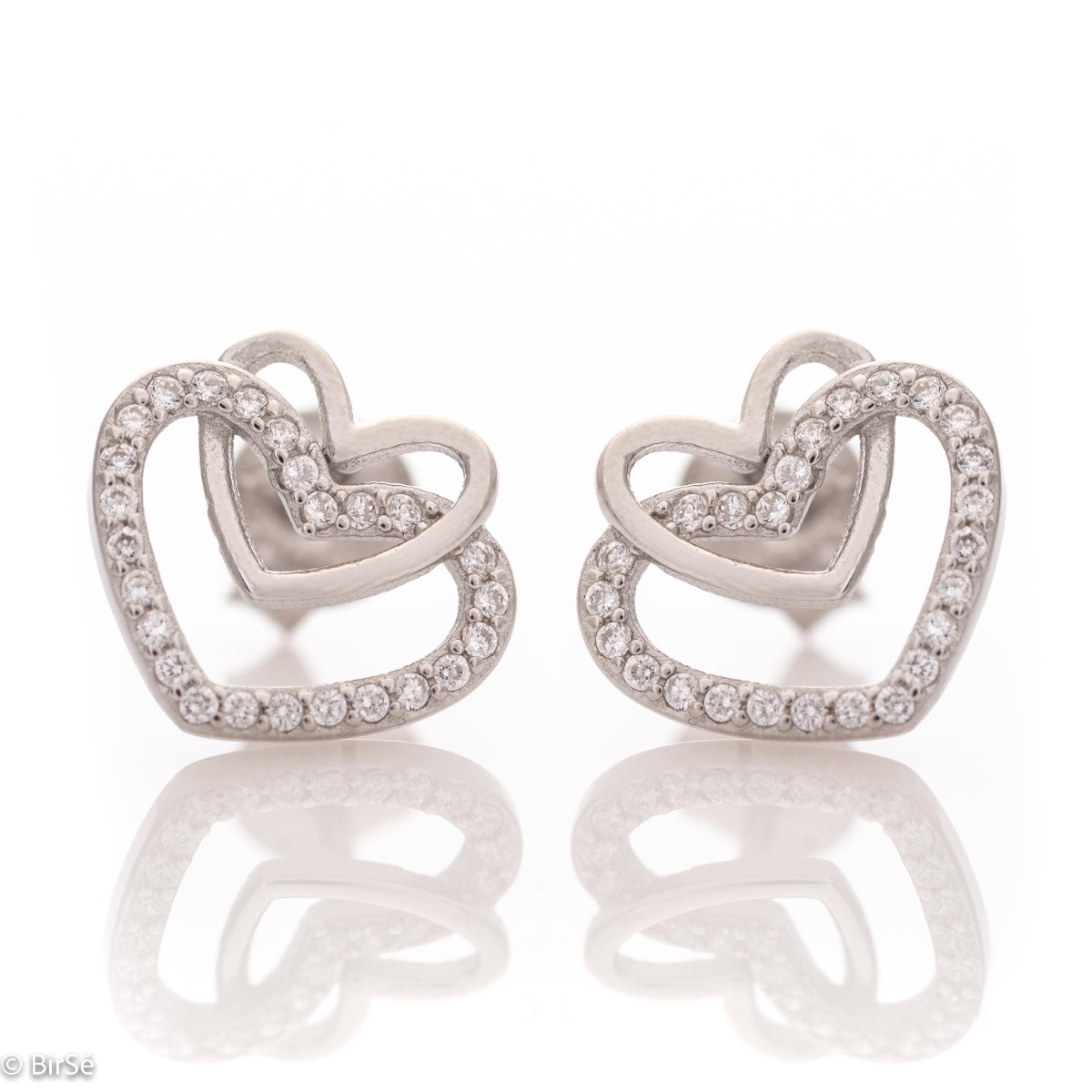 A charming model of women's earrings with an elegant design of intertwined hearts, completely formed by combining rhodium-plated silver with sparkling zircons. The fastening is with a pin - comfortable and practical. A beautiful look for your special mome