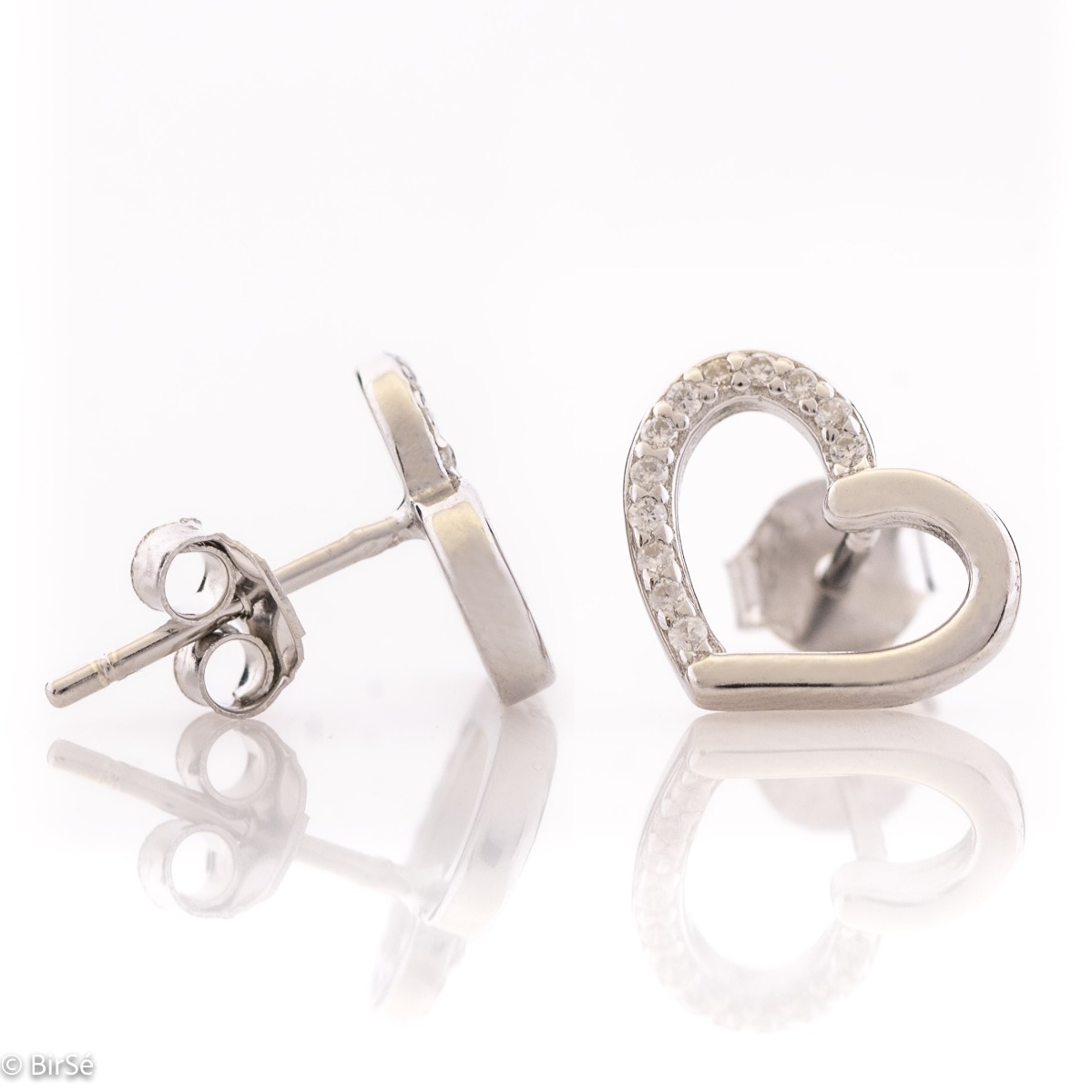 Beautiful and simple heart earrings made of rhodium silver, elegantly decorated with zircons. Screw fastening for convenience and security. They allow to be combined with silver jewelry with zircons.