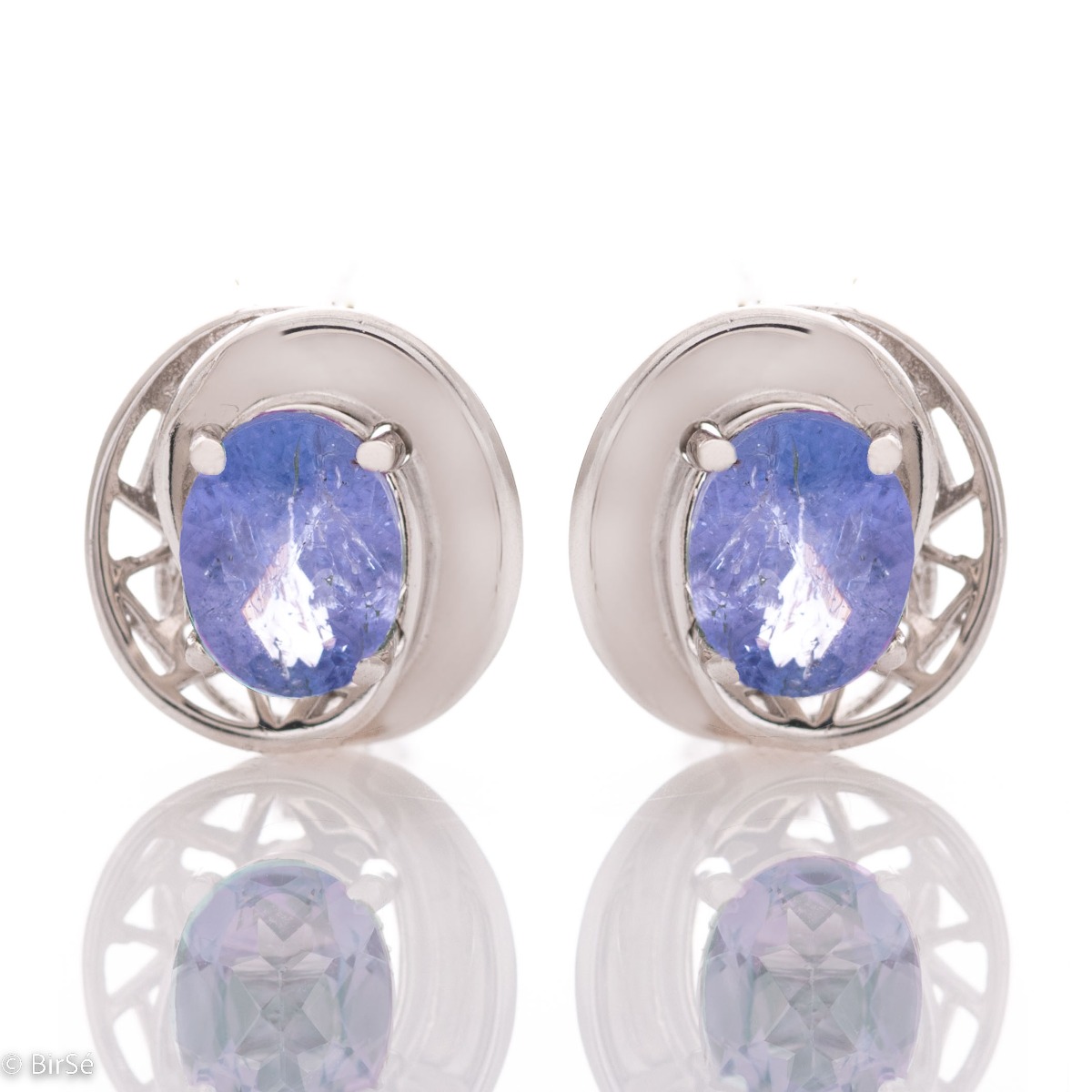 Sophisticated ladies' earrings, beautifully crafted from rhodium-plated silver, wrapped in a gentle embrace of enchanted tanzanite. Can be combined with a ring and pendant from the same collection.