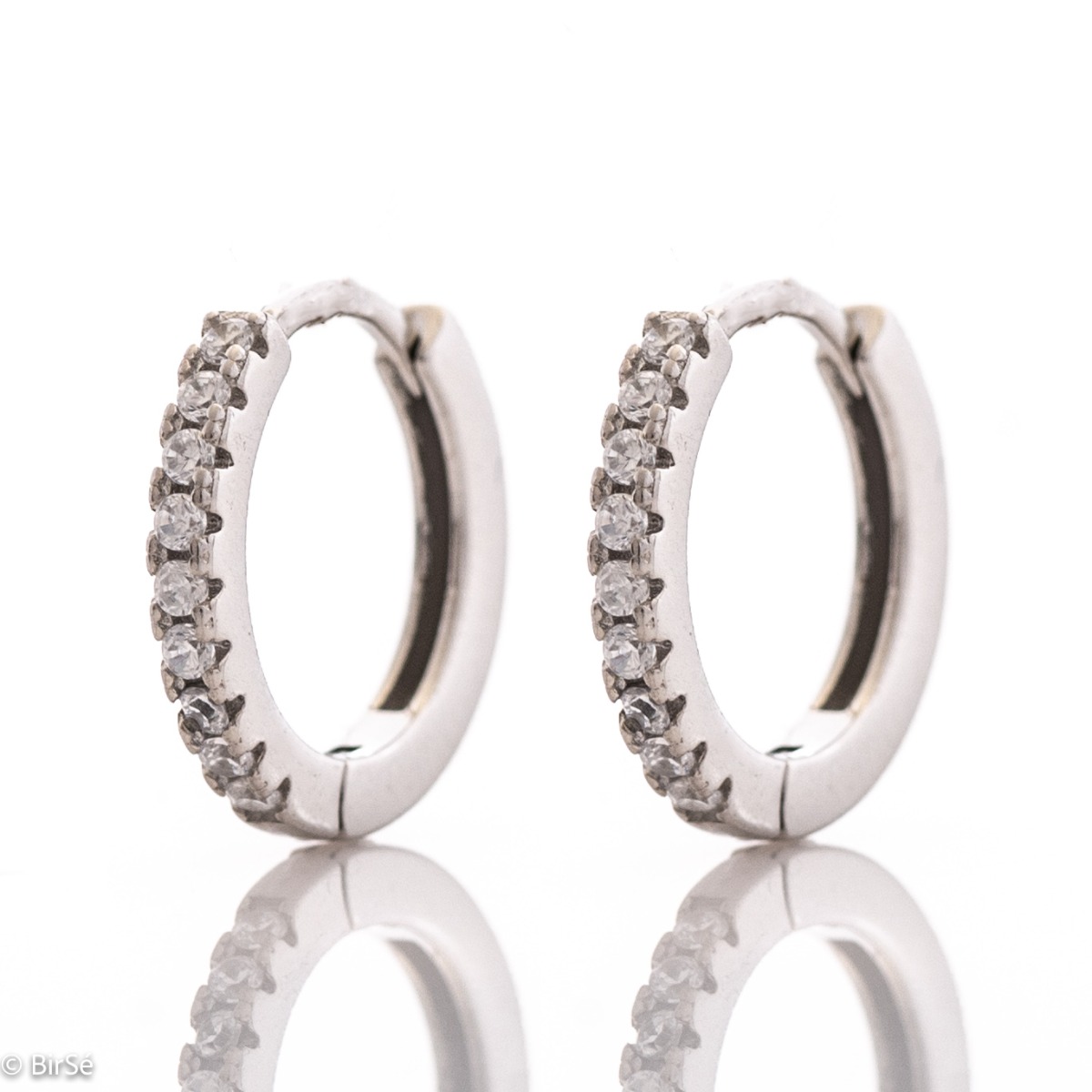 Small elegant silver earrings - rings, entirely made of rhodium-plated silver, decorated with sparkling zircons. The fastening is extremely comfortable and suitable for small children as well.