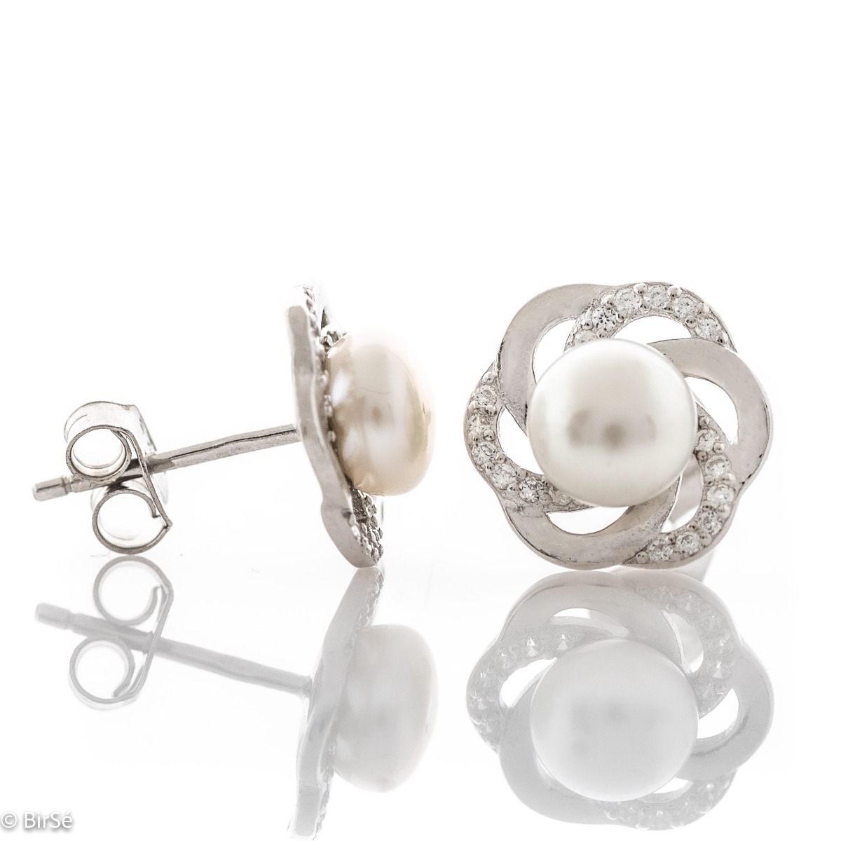 A beautiful model of women's earrings, entirely made of fine rhodium silver, with a comfortable and secure pin fastening. Delicate, sparkling zircons adorn the elements, stylishly surrounding an exquisite pearl. Charming and suitable for any occasion.