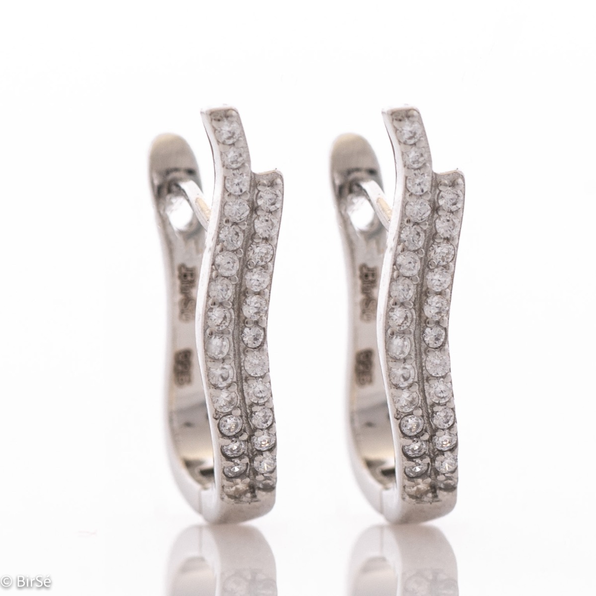 Elegant women's earrings with a spectacular design. Made entirely of rhodium-plated silver, with a comfortable English clasp and an extravaganza of sparkling zircons. Suitable for every day and any occasion.