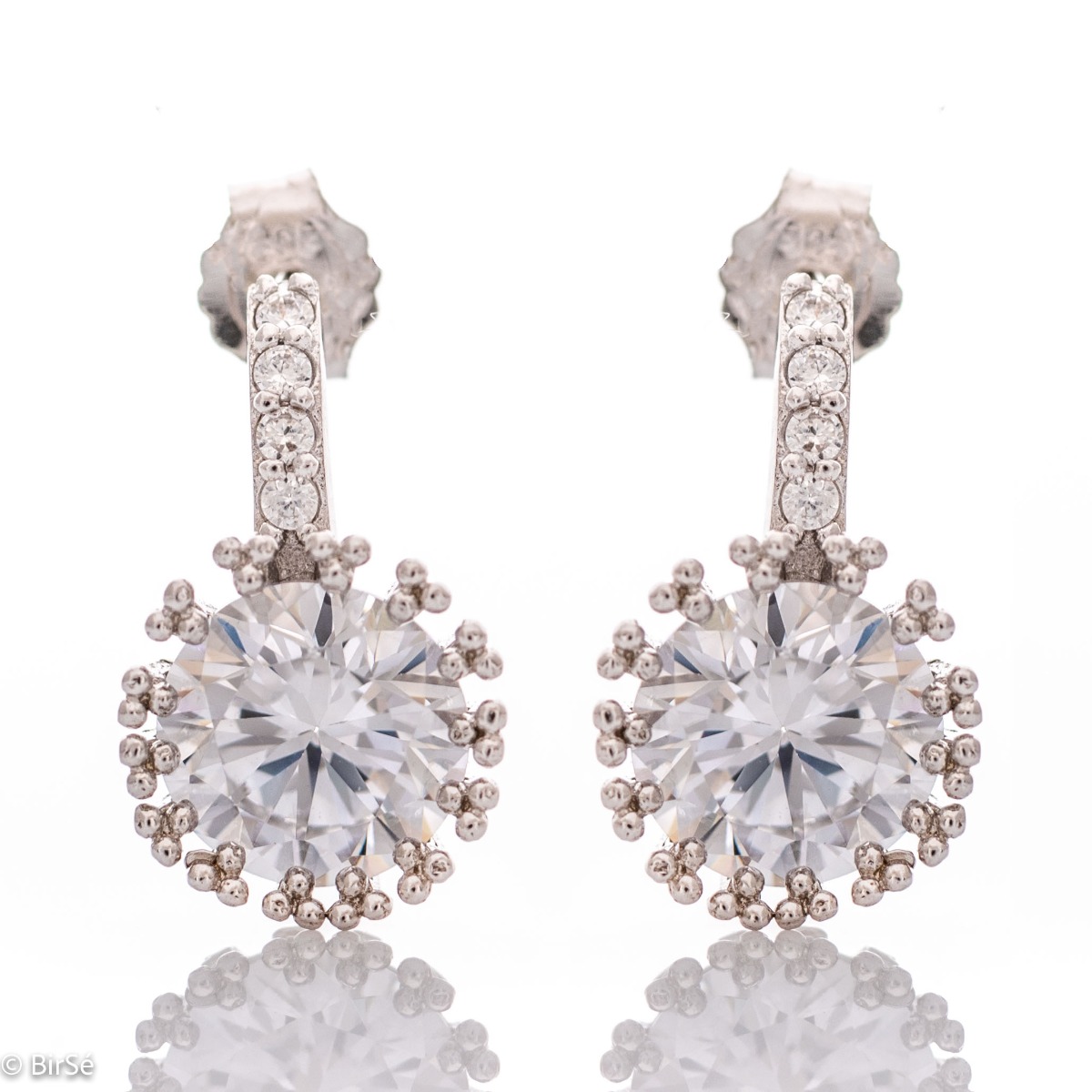 Elegant earrings in fine rhodium silver with a stylish design and a central sparkling zircon. The earrings have a pin fastening - practical and secure.