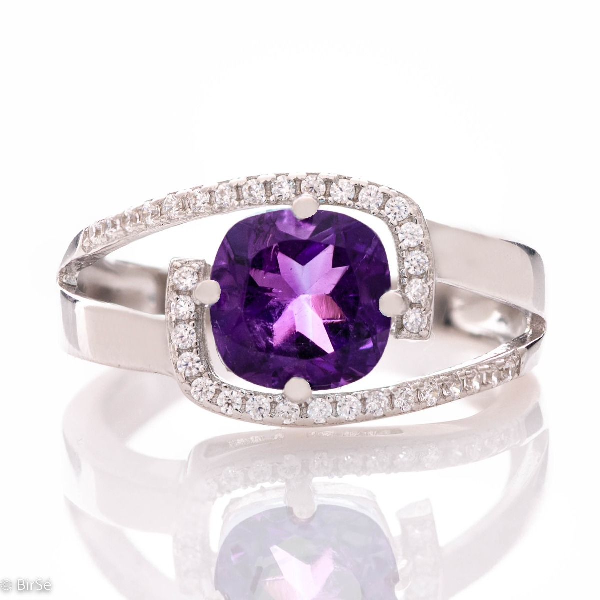 An elegant silver ring with an exquisite design, centered with a sparkling Amethyst, also known as the "Stone of Dreams". Delicate zircons add more sparkle to the jewelry.