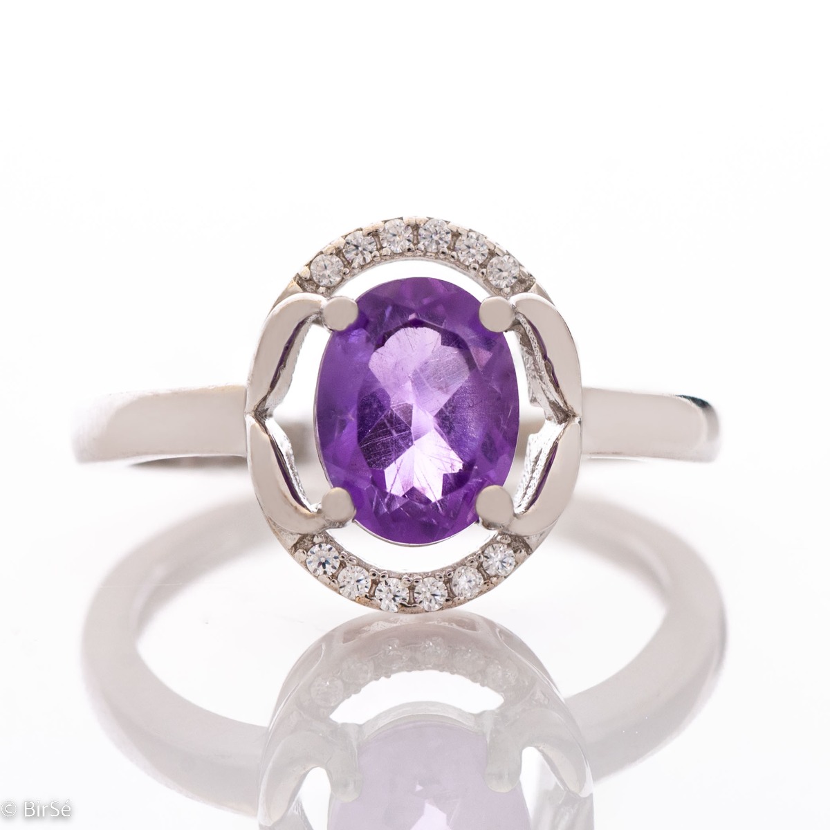 An elegant women's ring, shaped in oval elements and a gentle, beautiful look. Stylish craftsmanship from a fine combination of rhodium silver, zircons and natural amethyst. Complete with the same model of charming English clasp earrings.