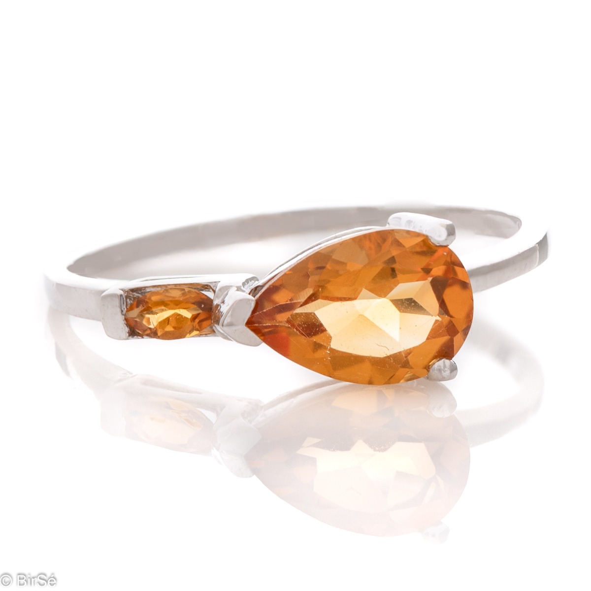 The golden glow of a natural citrine stone, complimented by a glamourous, exquisite and fine craftsmanship made entirely of beautiful rhodium silver - our new offering for women's ring, part of a charming set with a pendant and dangle earrings.