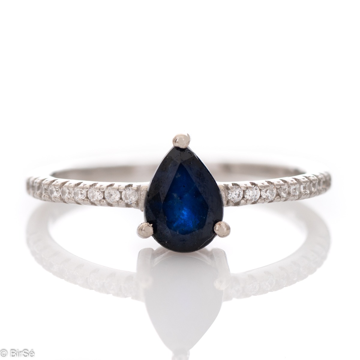 Exquisite Ring of Rhodised Silver with Drip-shaped Sapphire and Enchanting Zircons 0,75 ct.