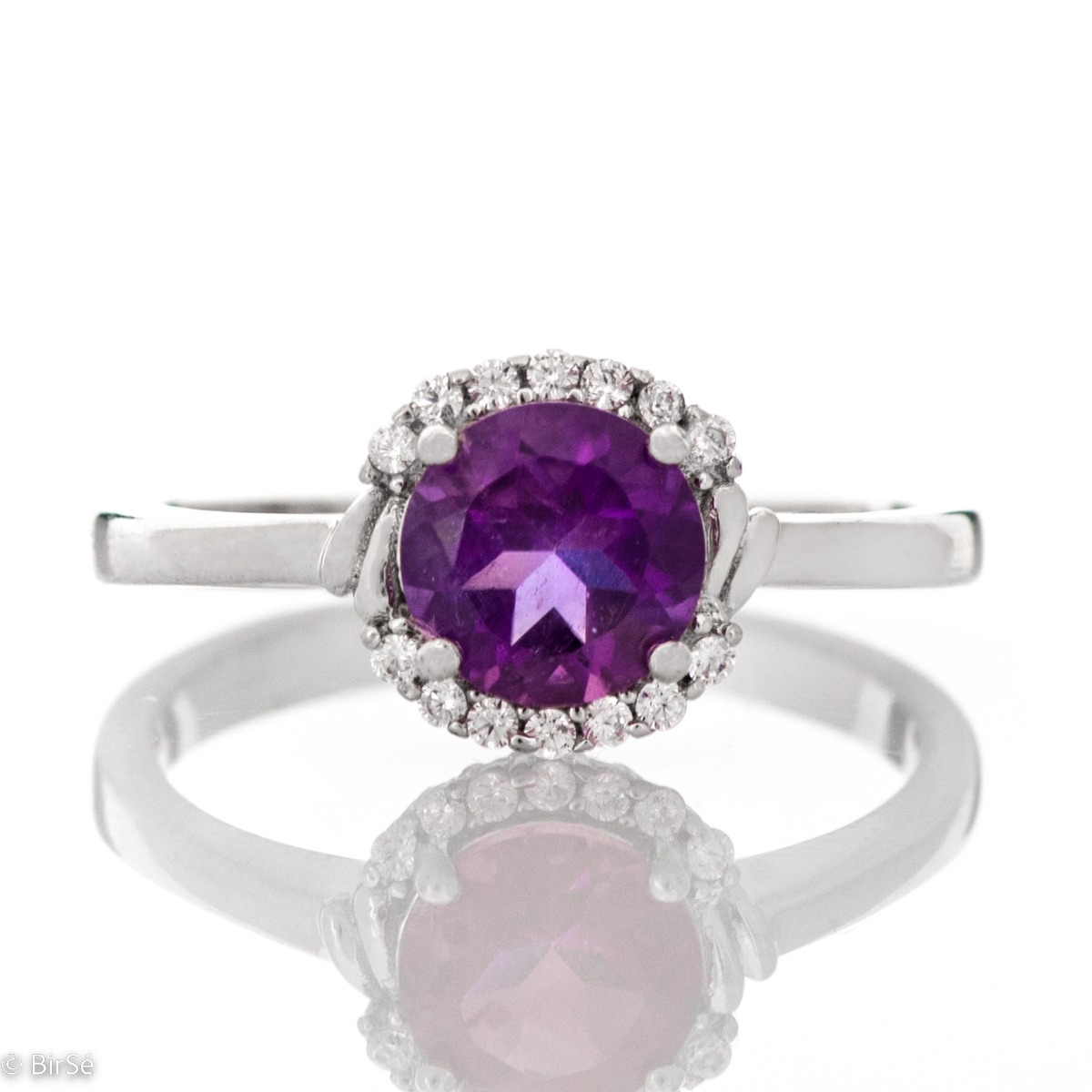 An elegant women's ring made of a delicate combination of rhodium-plated silver, natural amethyst and sparkling zircons. Part of a silver pendant and earring set from the same collection and the same striking design.